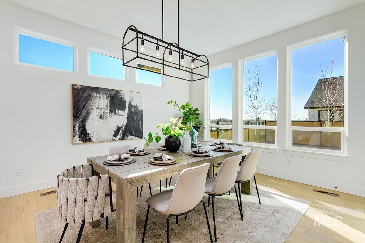 Dining room with plenty of natural light and light wood-style flooring