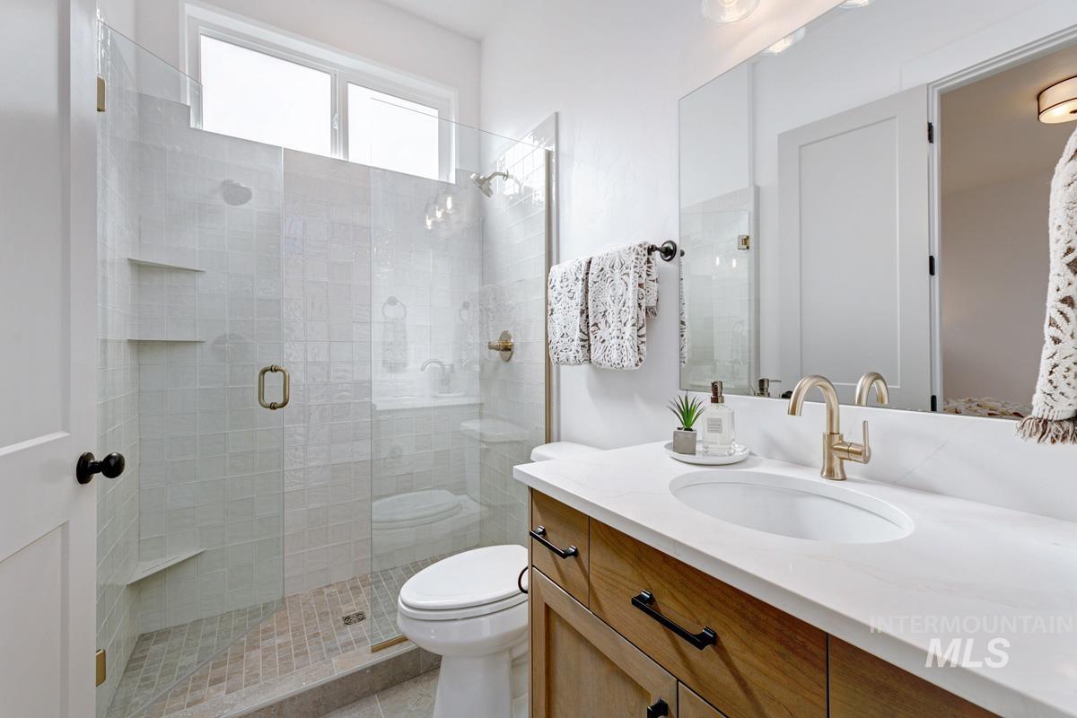 Full bath with vanity and a shower stall