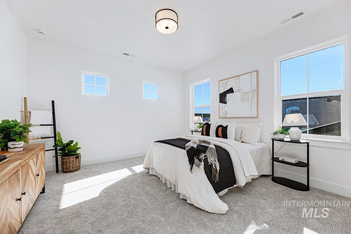 Bedroom featuring light colored carpet and baseboards