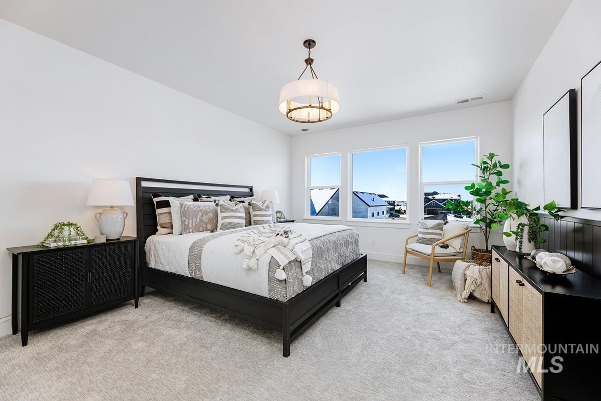 Bedroom featuring light colored carpet and baseboards