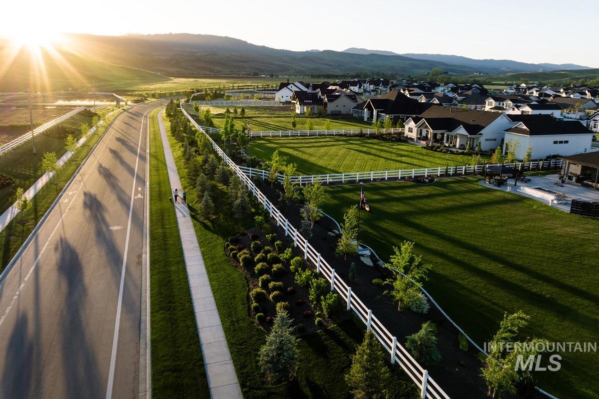 Overview of rural landscape featuring a mountainous background and nearby suburban area