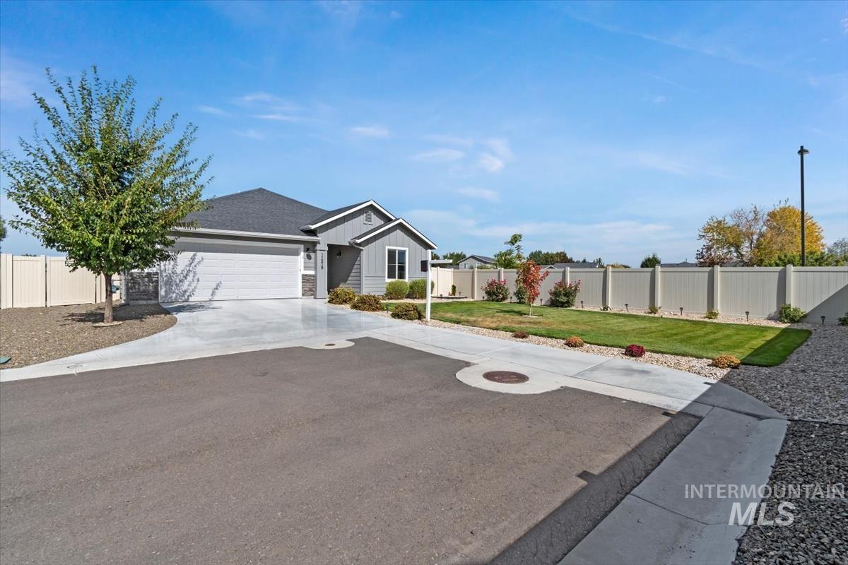 View of front of property featuring driveway, board and batten siding, and a garage