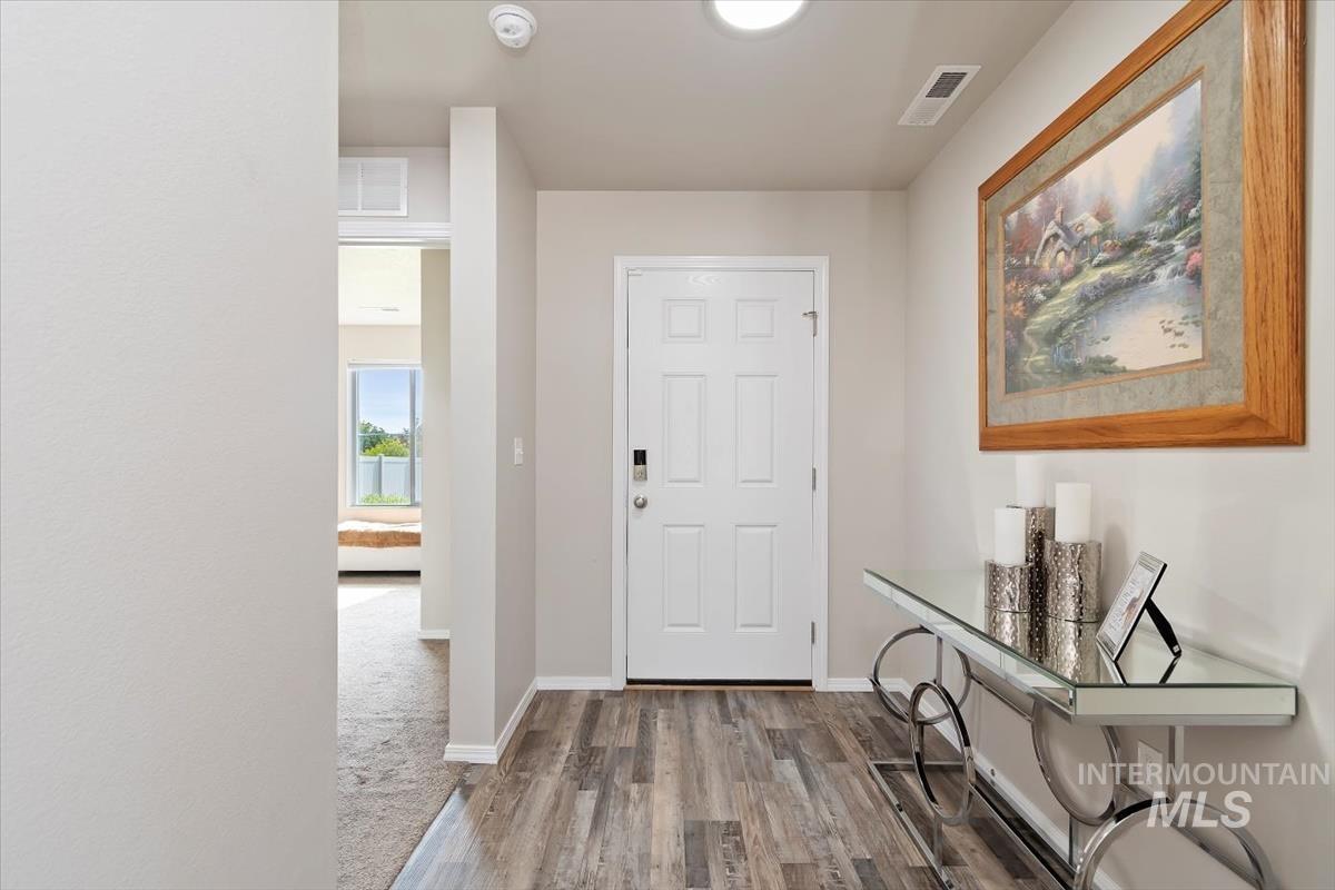 Foyer with wood finished floors and baseboards