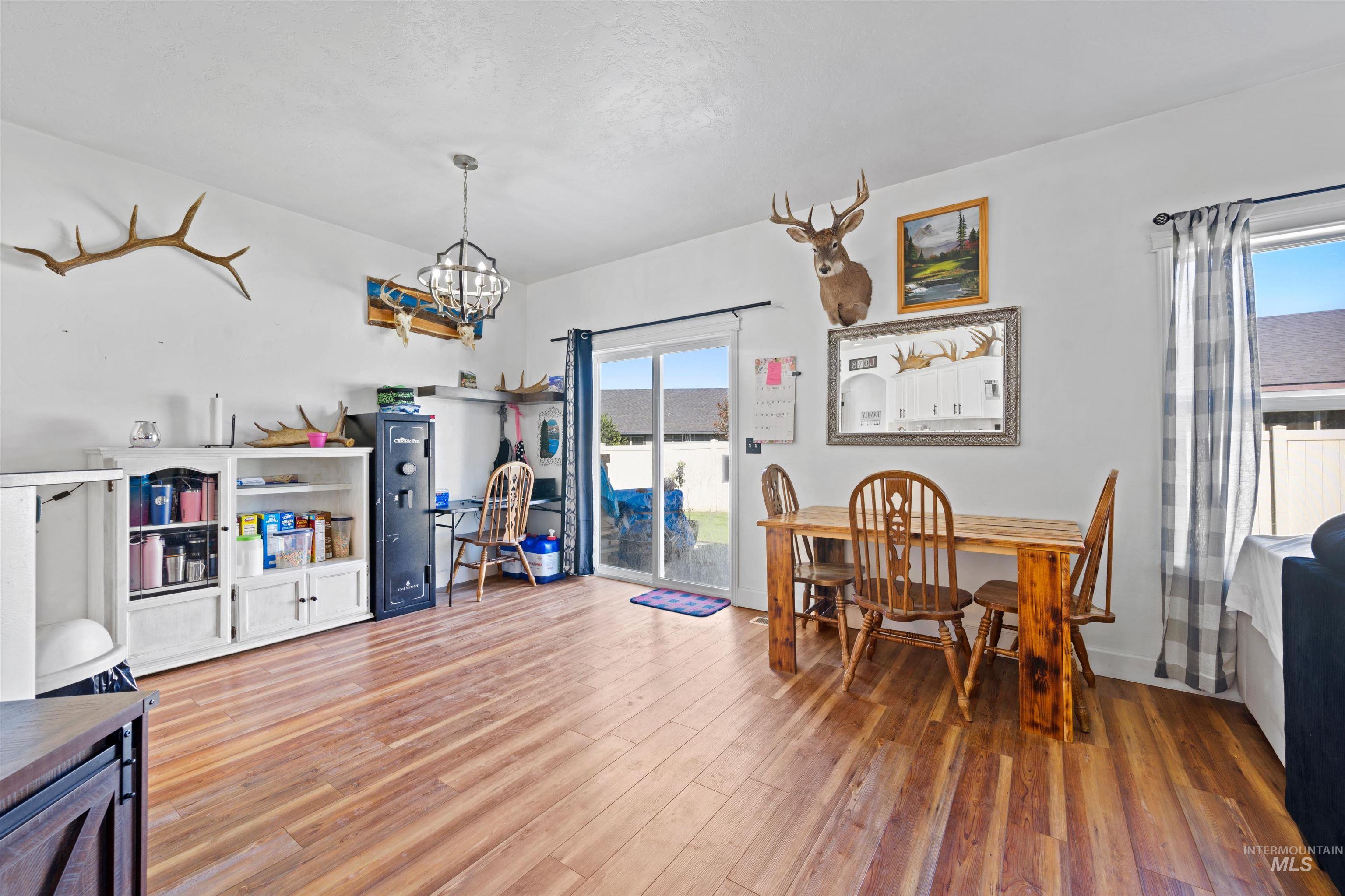 Dining room featuring wood finished floors and a chandelier