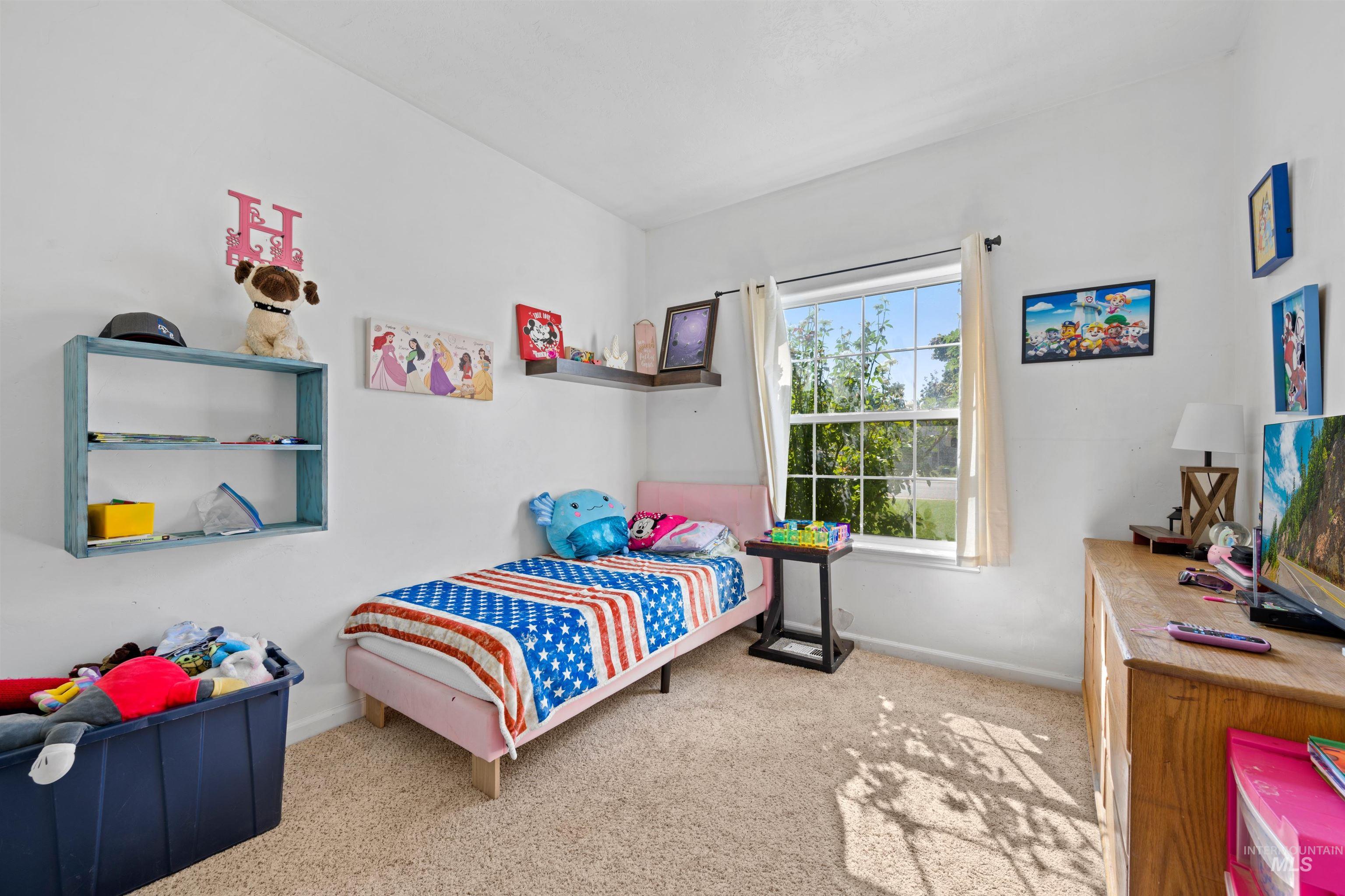 Bedroom featuring light colored carpet and baseboards