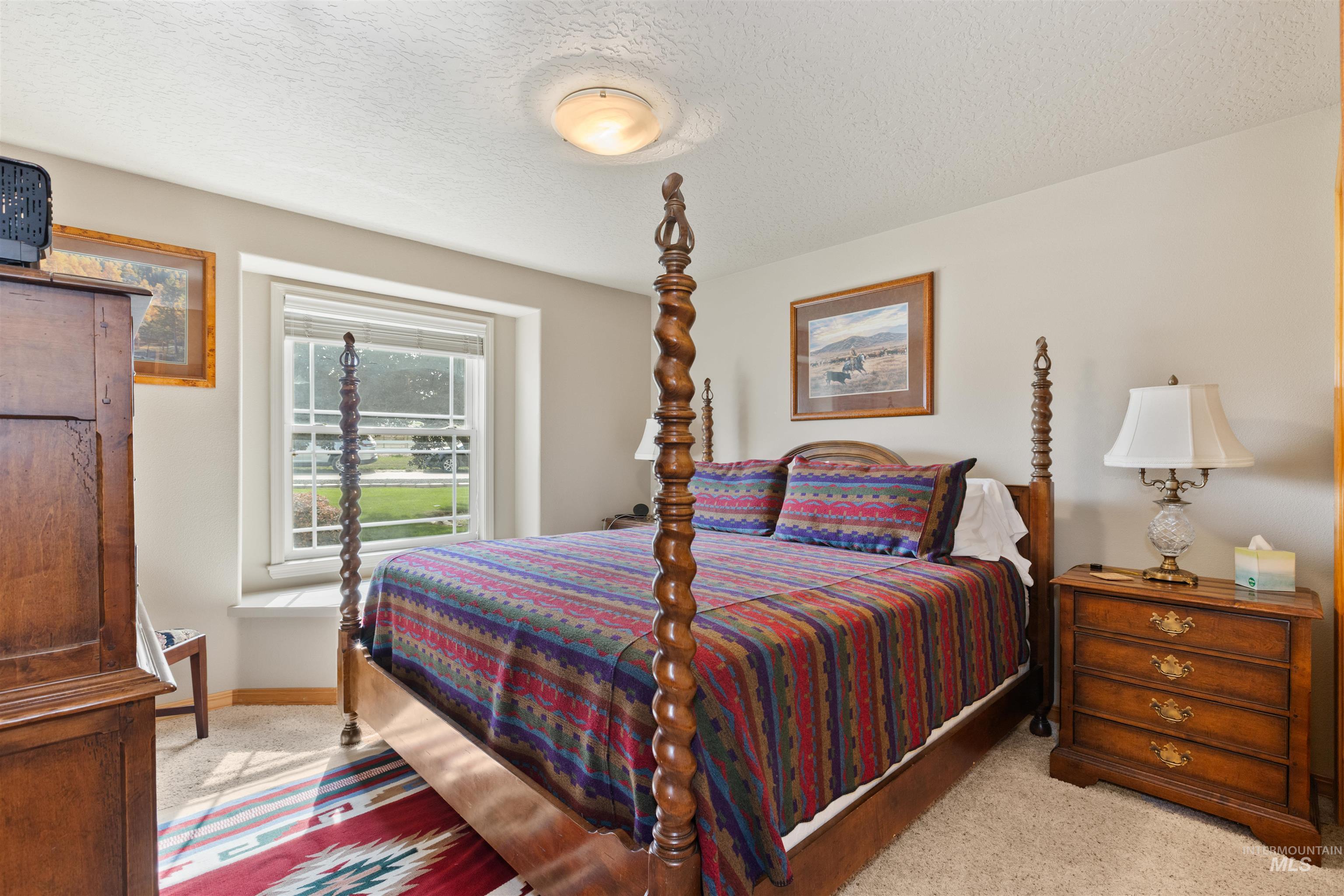 Bedroom featuring a textured ceiling and carpet flooring
