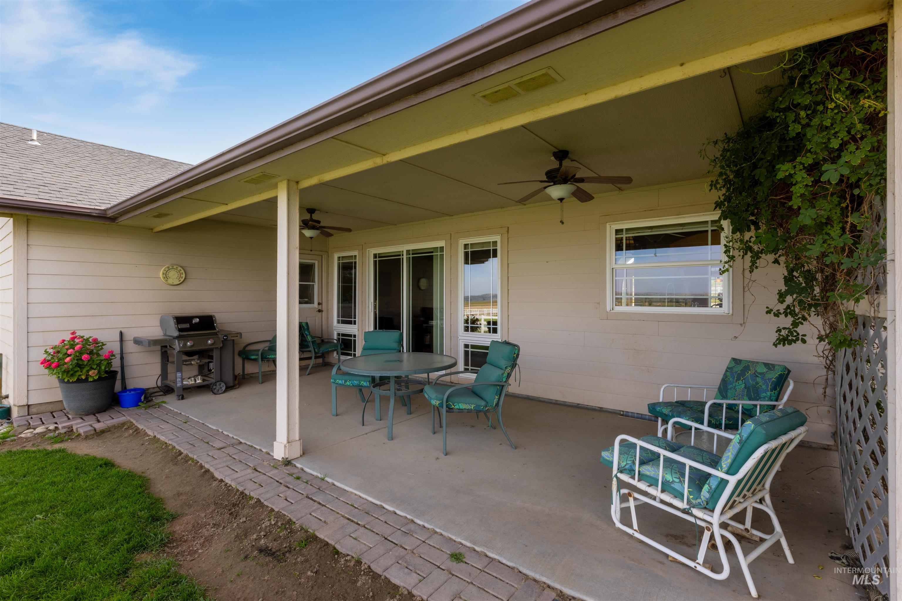 View of patio / terrace featuring a ceiling fan, grilling area, and outdoor dining space