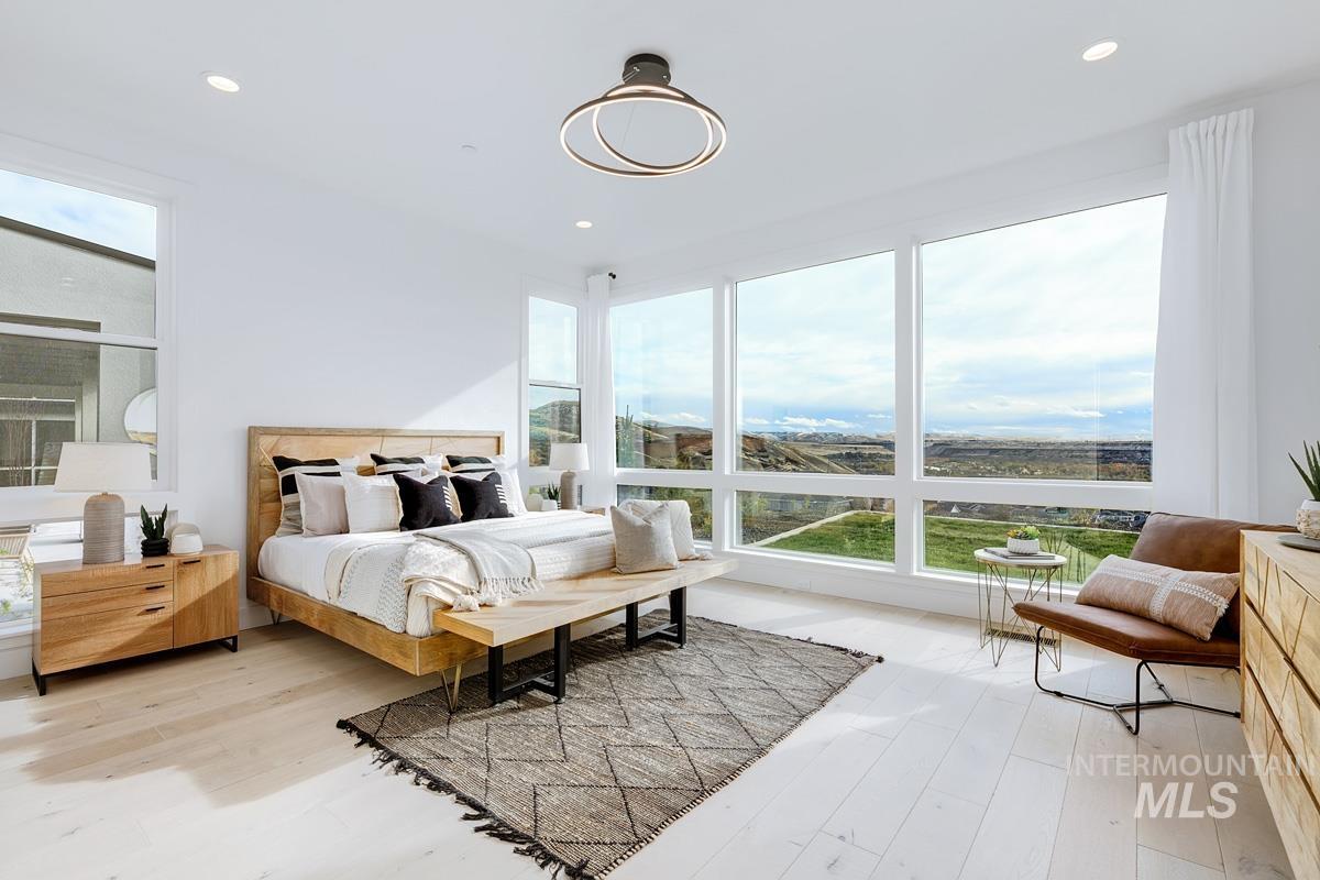 Bedroom with light wood-type flooring and recessed lighting