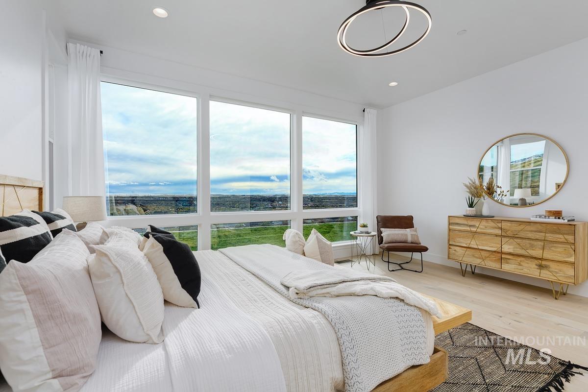 Bedroom with wood finished floors and recessed lighting