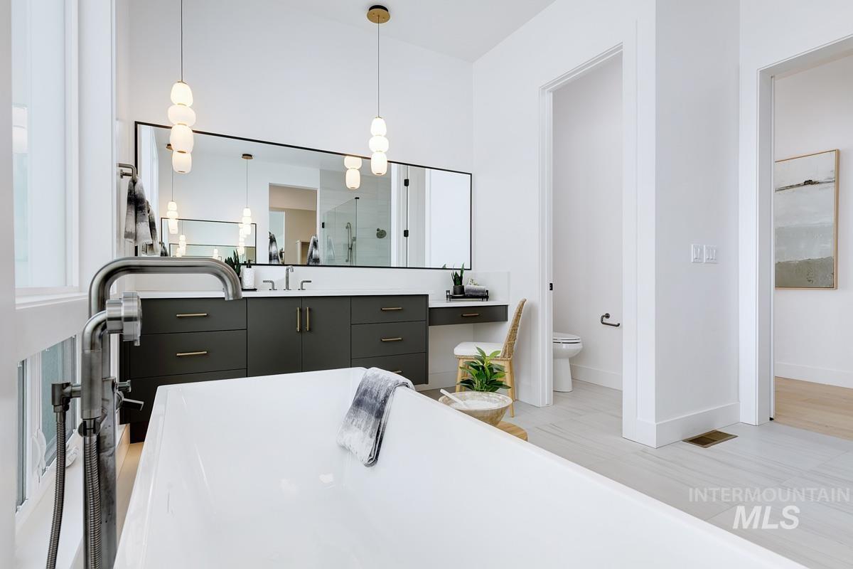 Full bathroom with vanity, a freestanding bath, and a stall shower