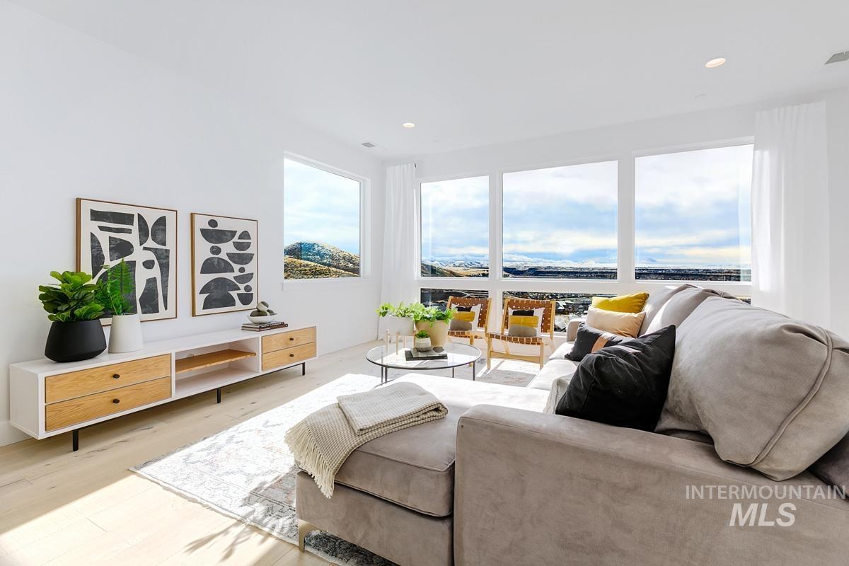 Living area featuring wood finished floors and recessed lighting
