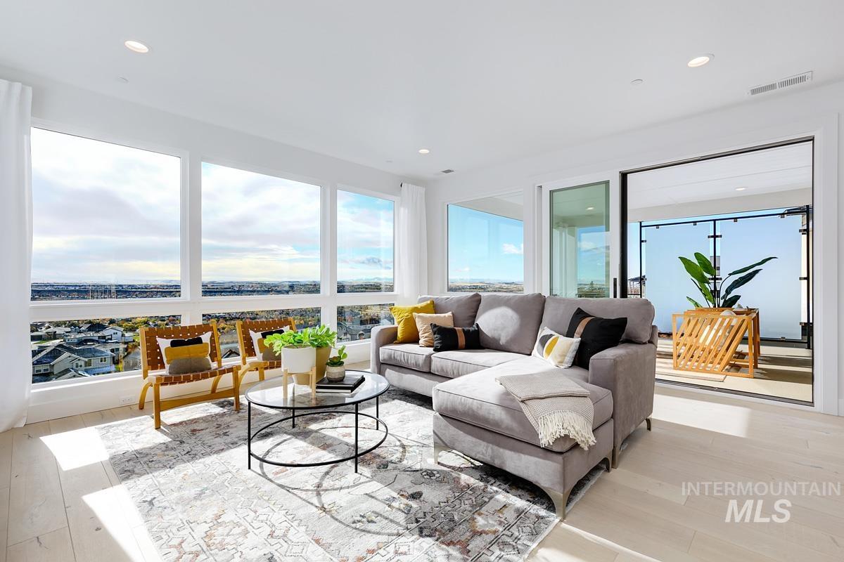 Living room with light wood finished floors, recessed lighting, and healthy amount of natural light