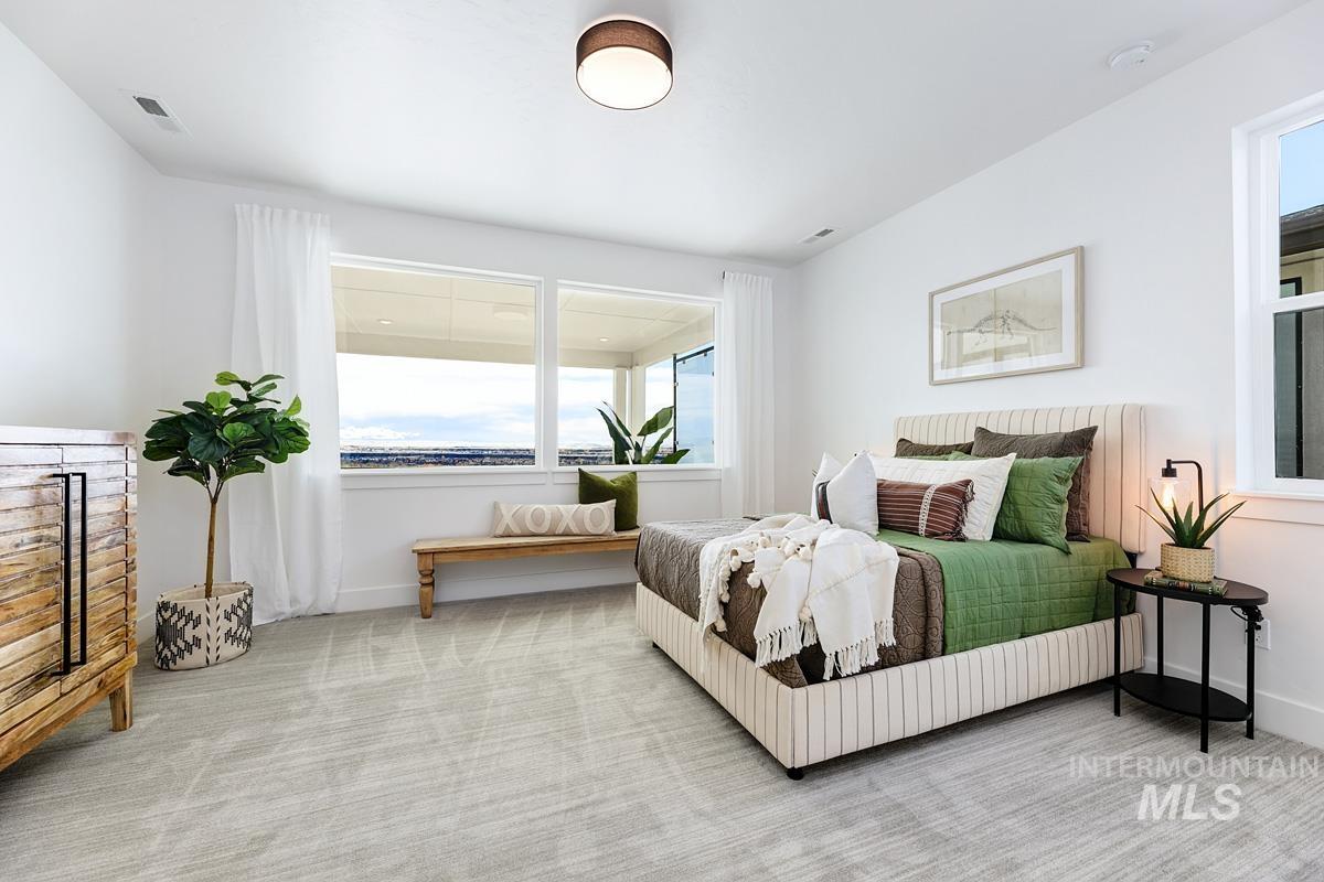 Bedroom featuring carpet flooring and baseboards