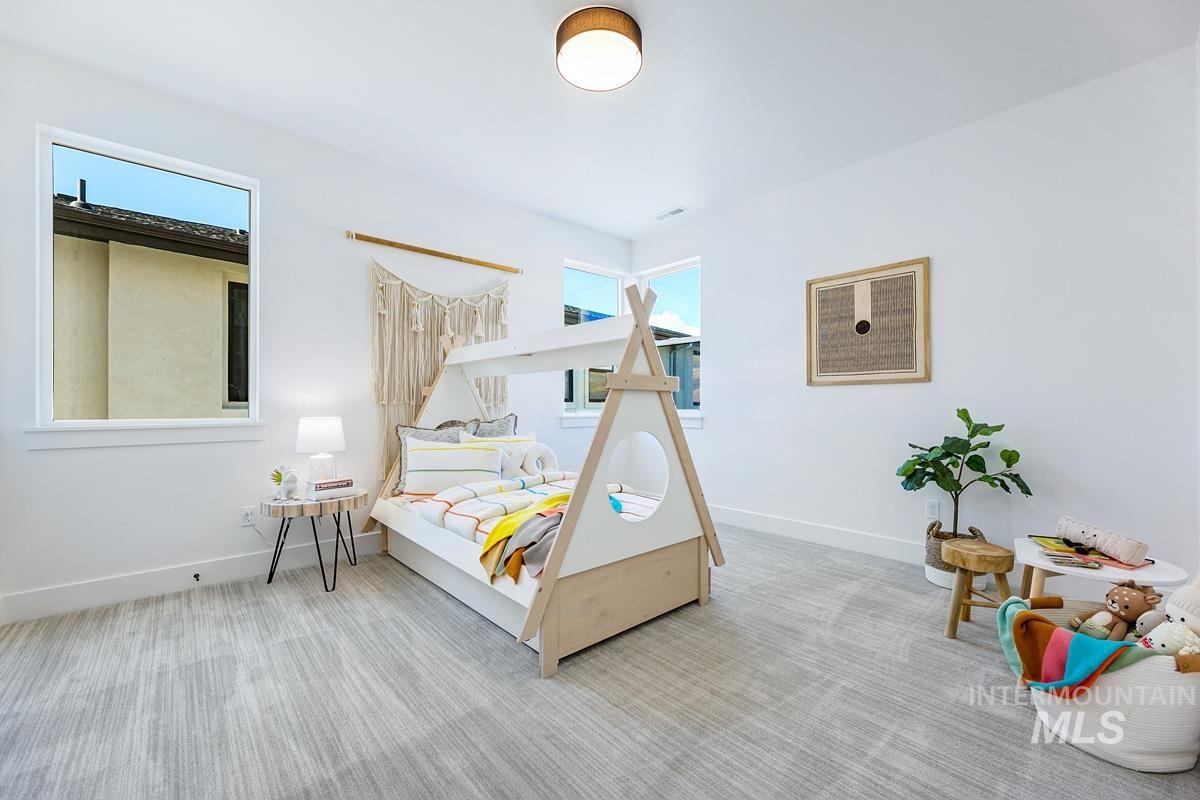 Bedroom featuring carpet flooring and baseboards