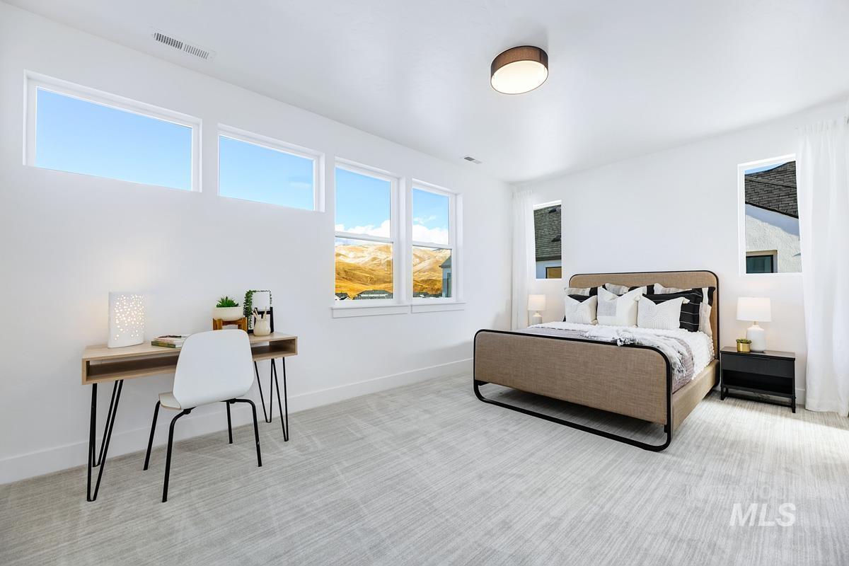 Bedroom featuring carpet flooring and baseboards