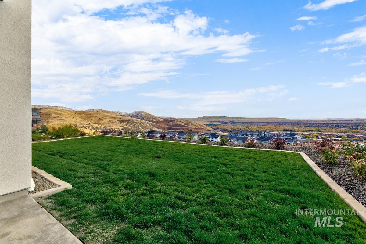 View of grassy yard featuring a mountain view