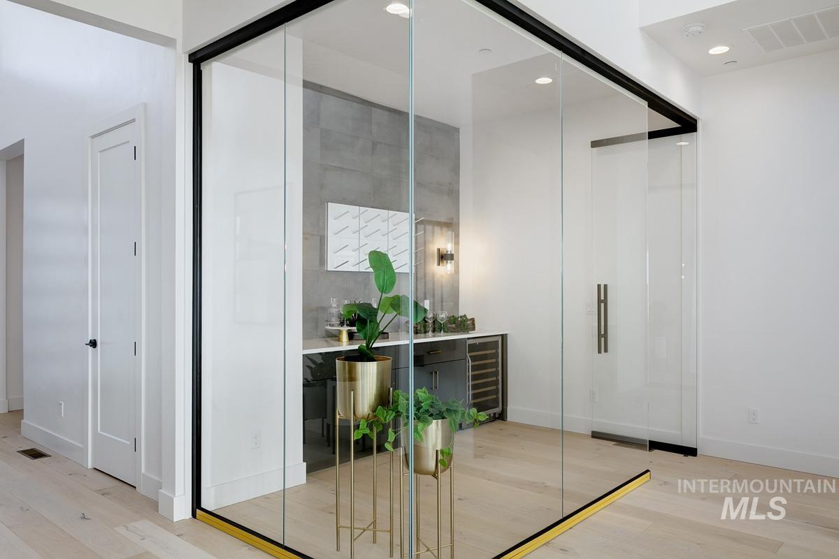 Interior space featuring wood finished floors, beverage cooler, and recessed lighting