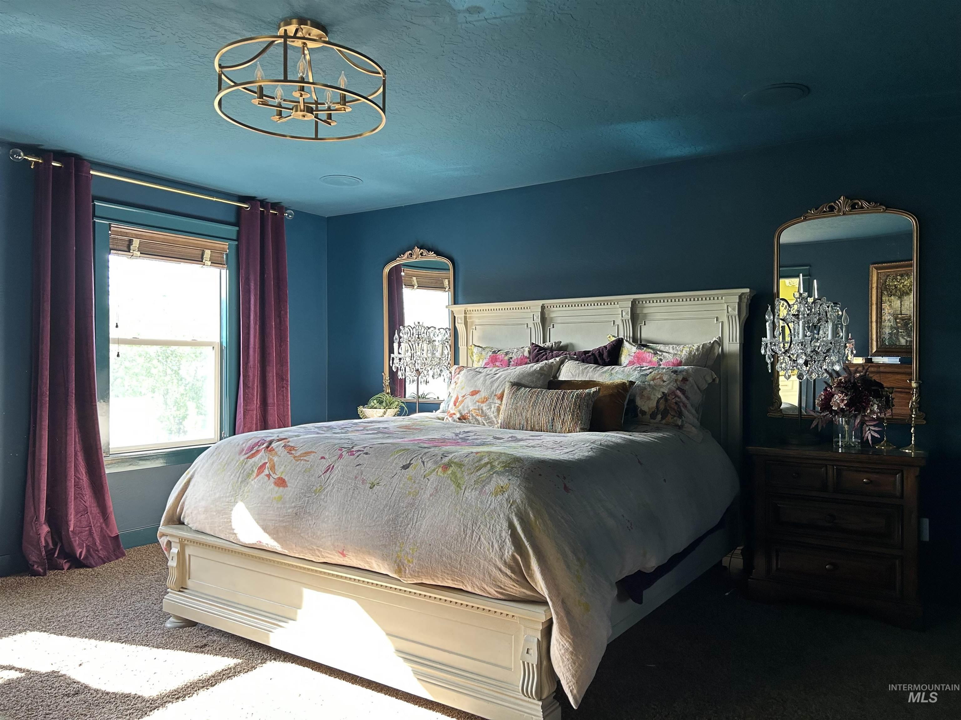 Bedroom featuring carpet floors, a textured ceiling, and a chandelier