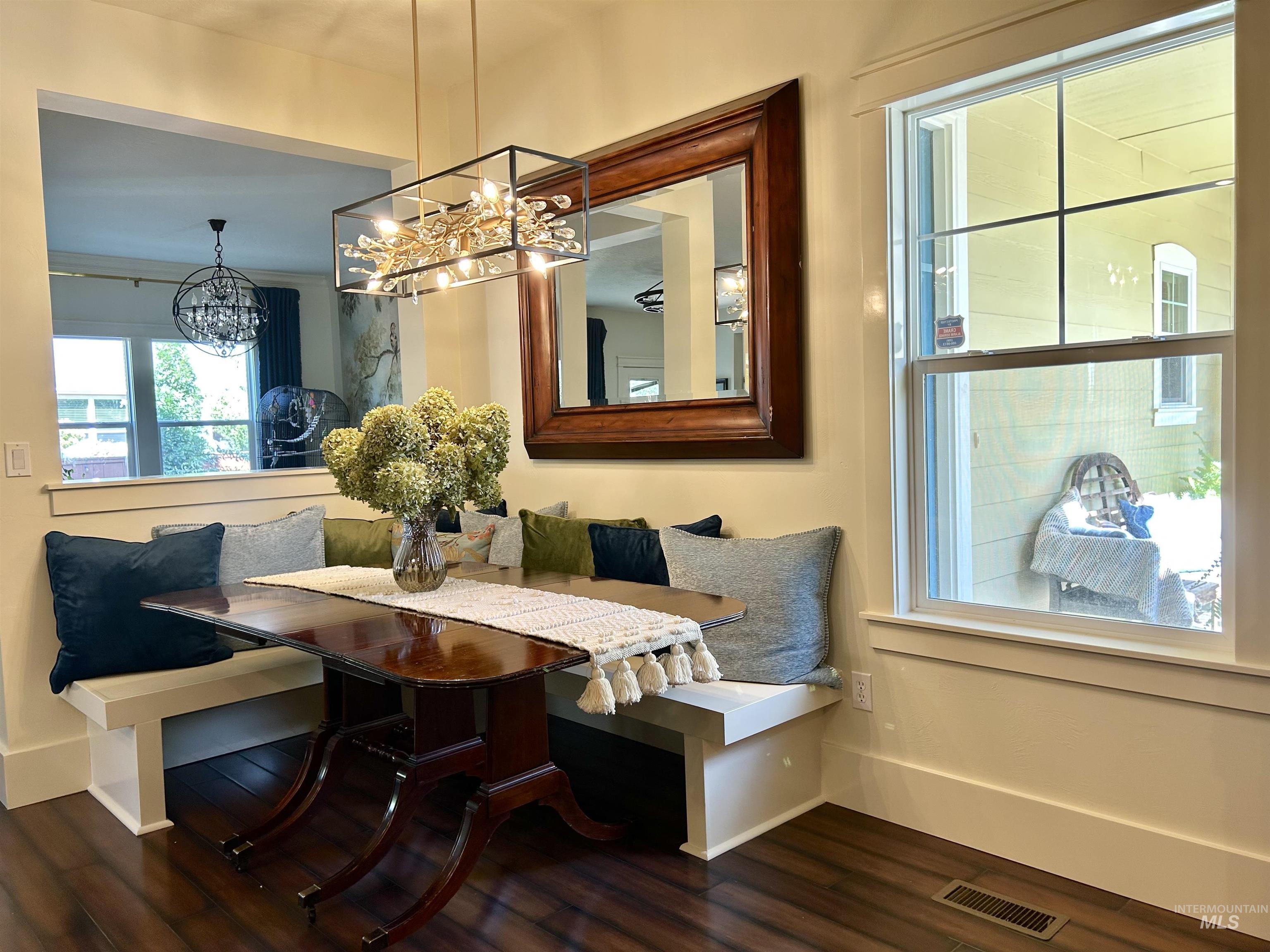 Dining area with breakfast area and dark wood-style floors