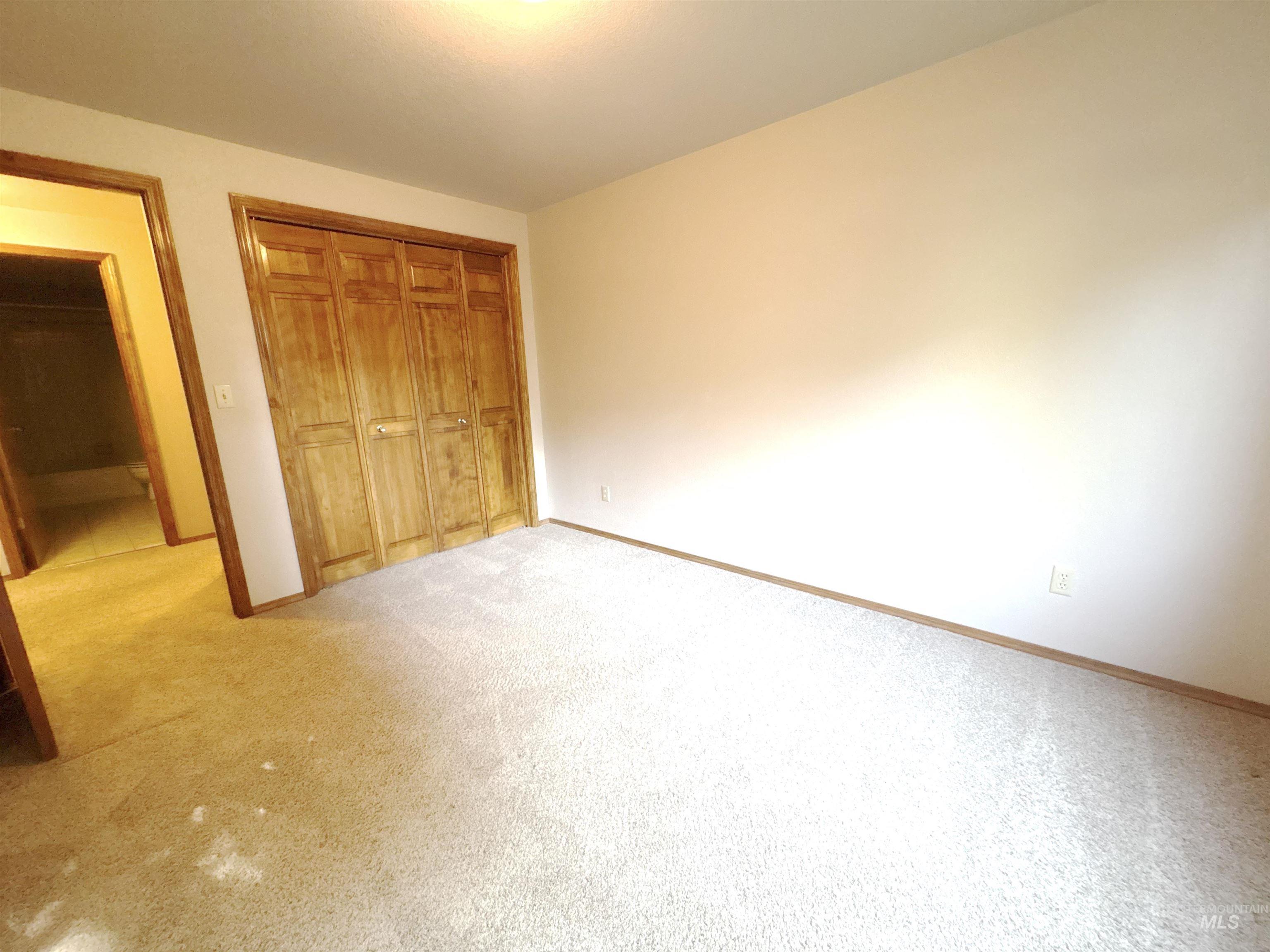 Unfurnished bedroom with carpet flooring and a closet