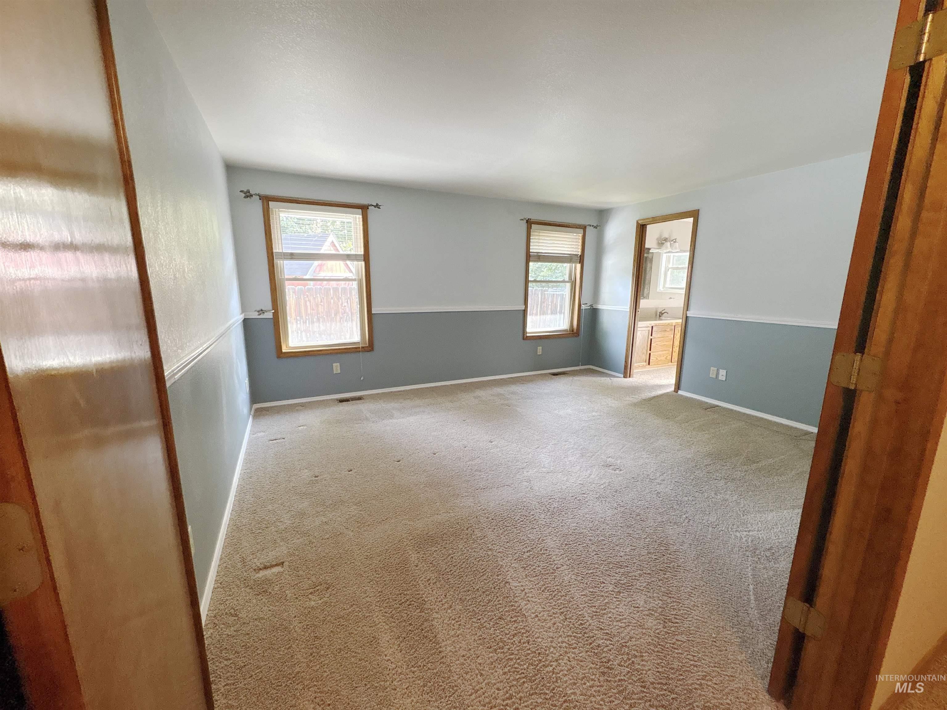 Carpeted spare room with baseboards