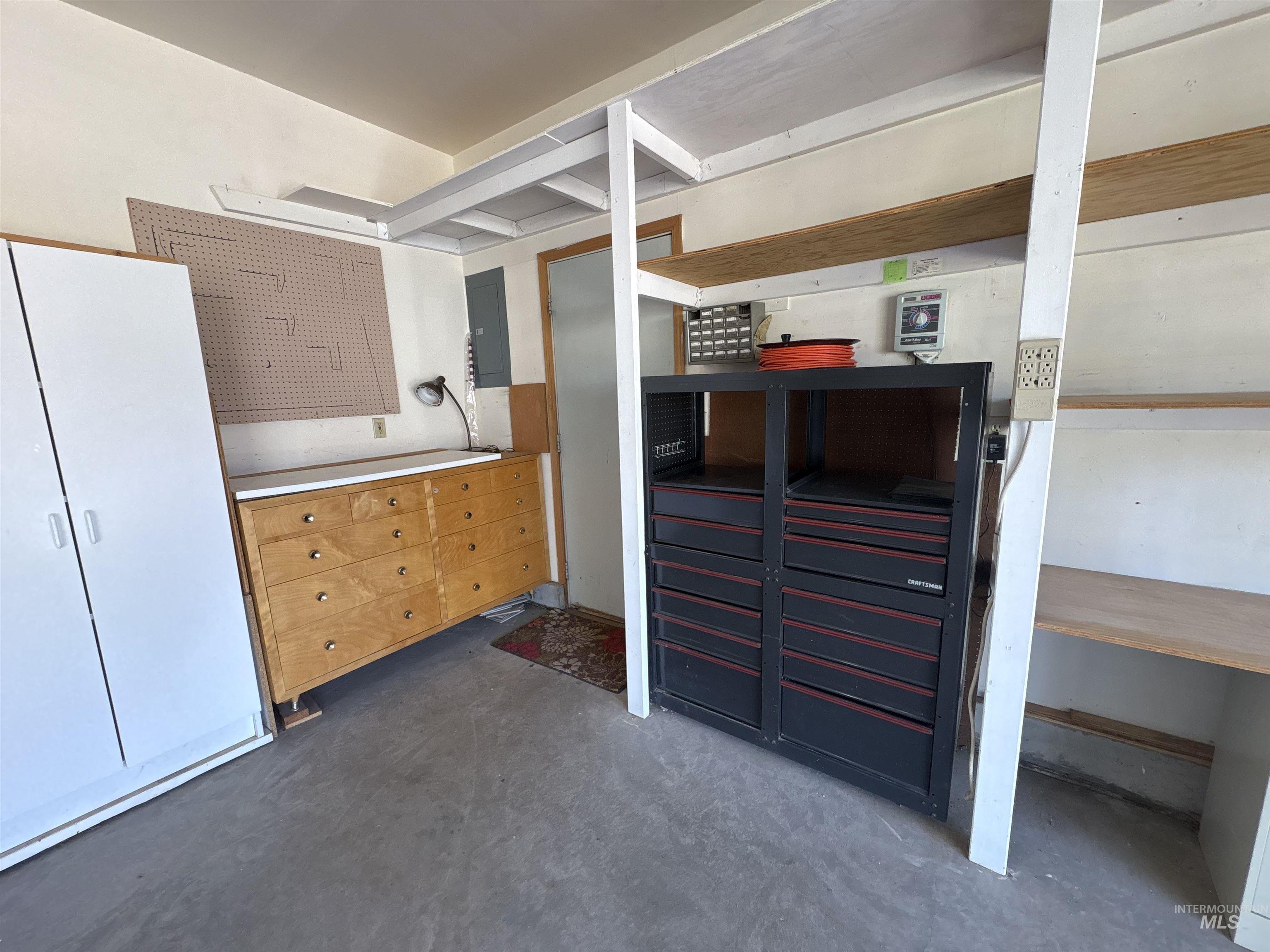 Kitchen with concrete flooring and electric panel
