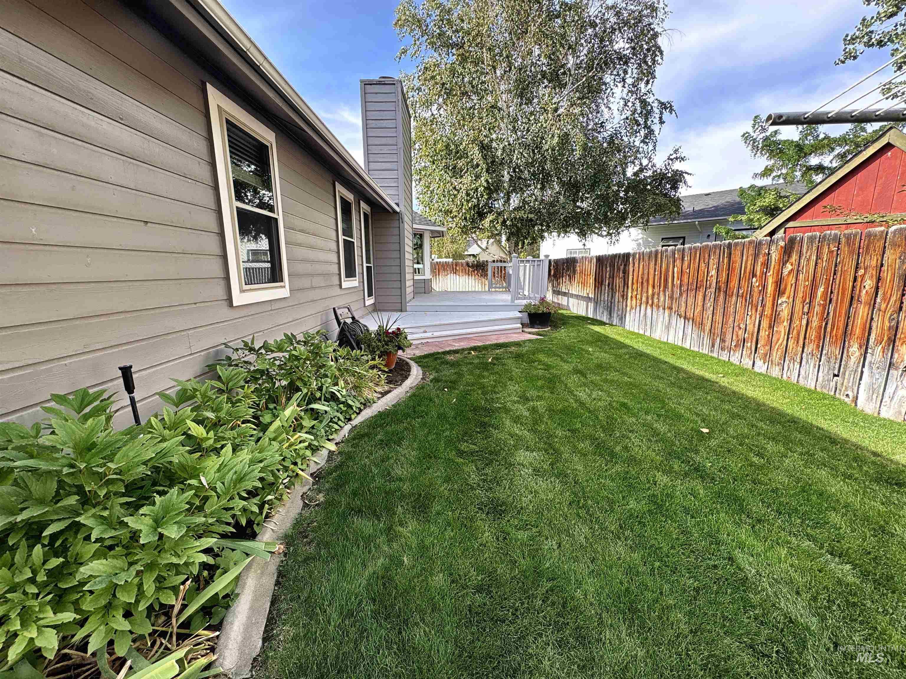 Fenced backyard featuring a wooden deck
