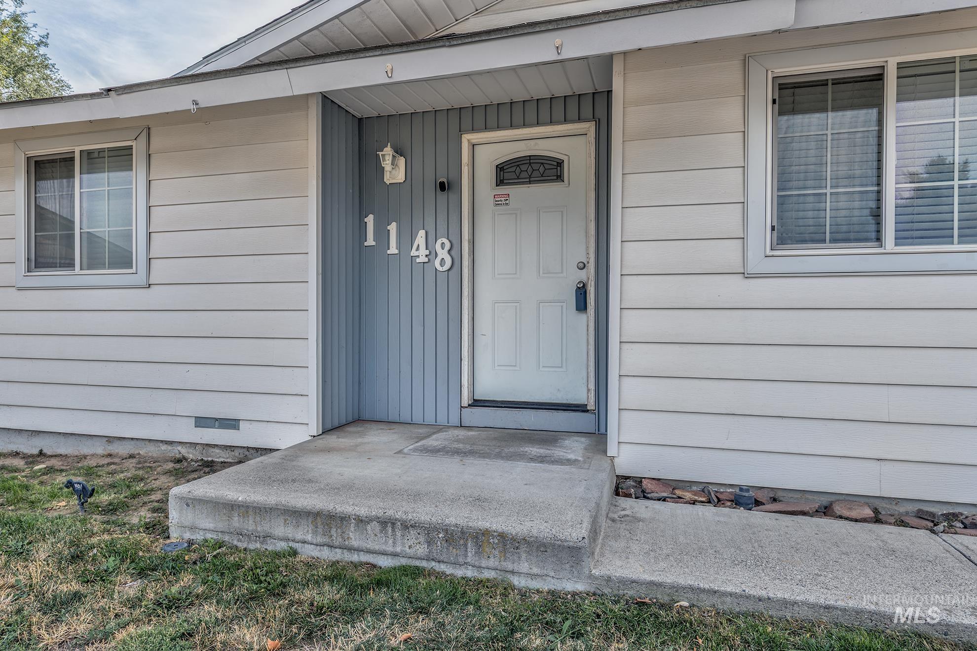 Doorway to property featuring a porch