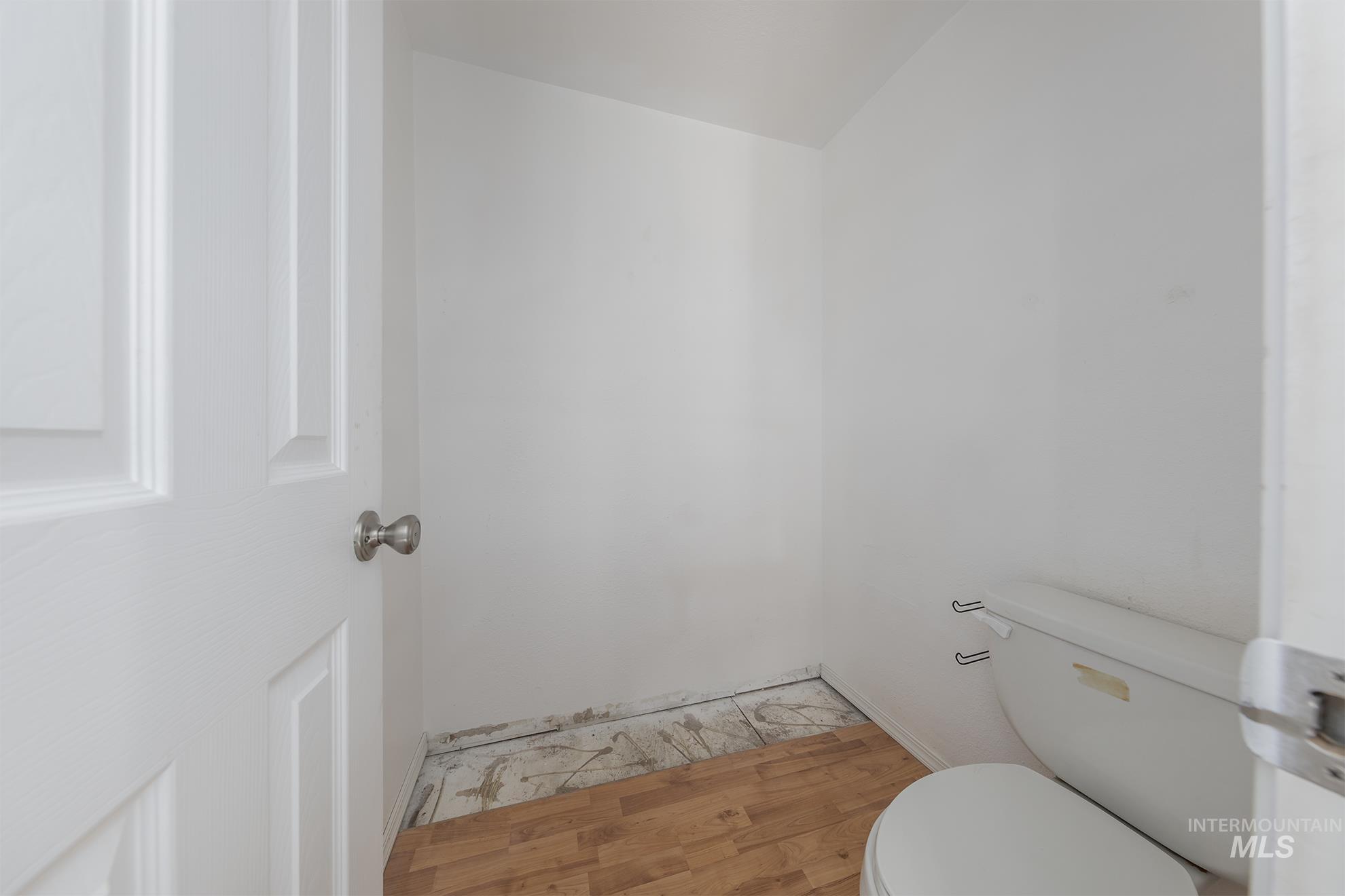 Bathroom with wood finished floors and toilet