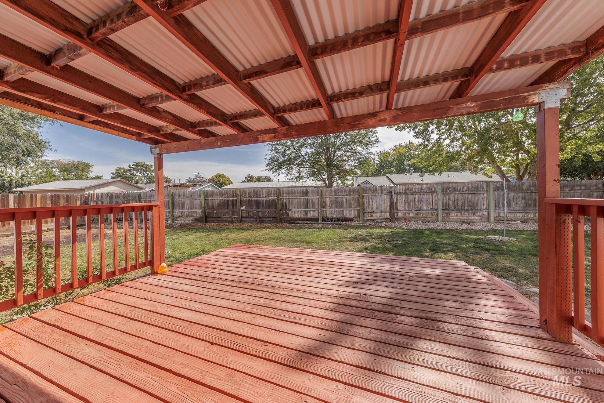 Wooden deck featuring a fenced backyard