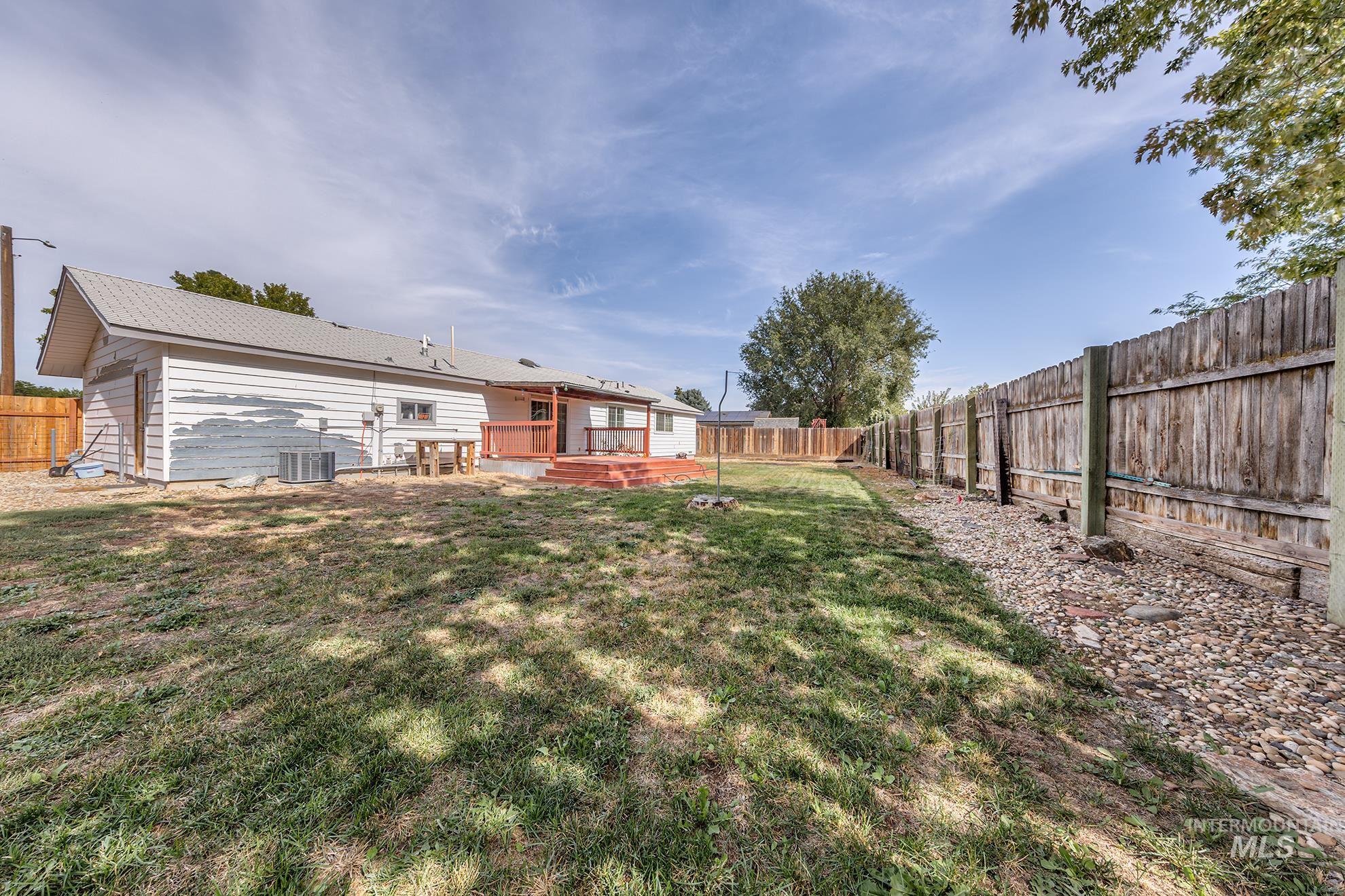 Fenced backyard with a wooden deck