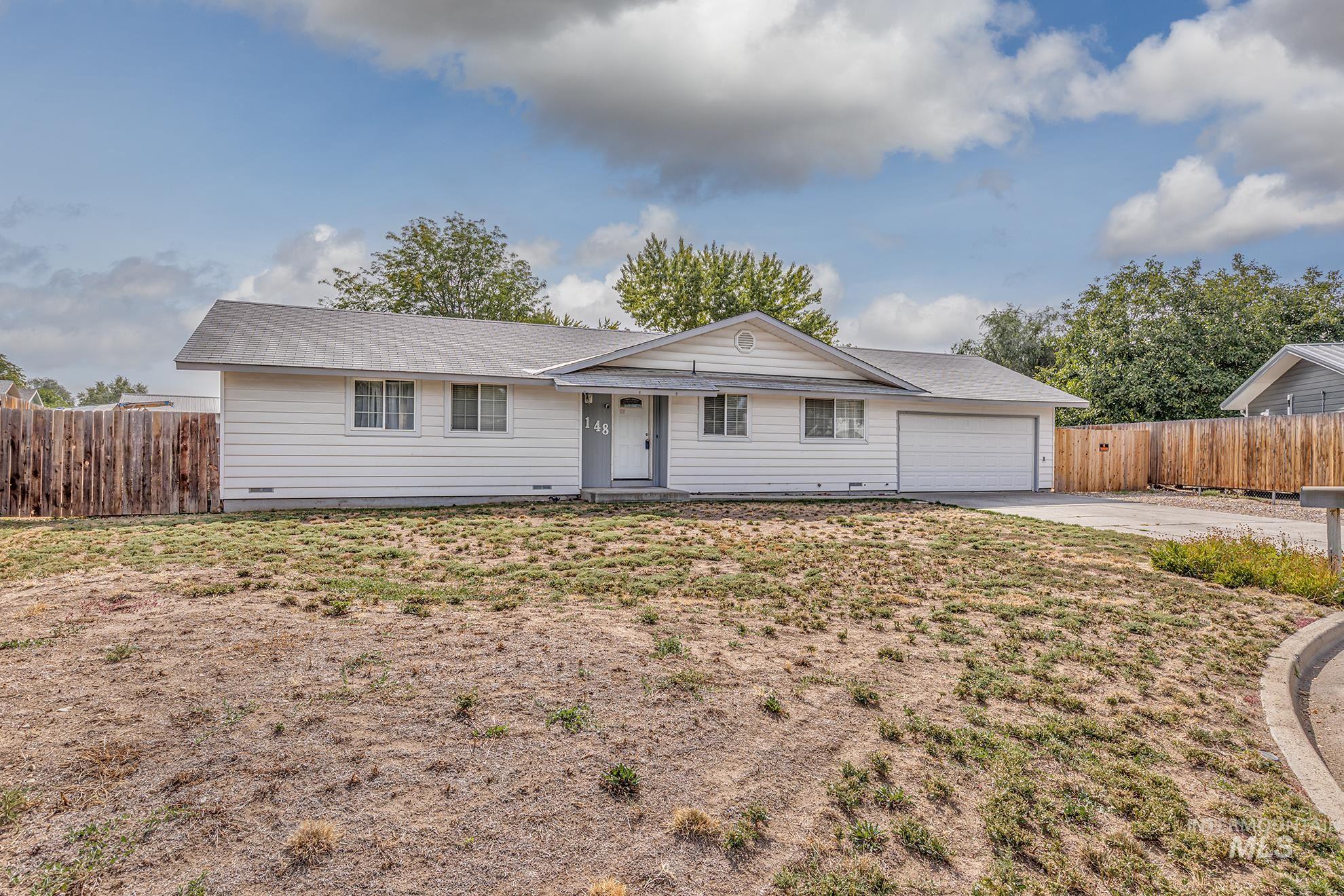 Single story home with driveway and a garage