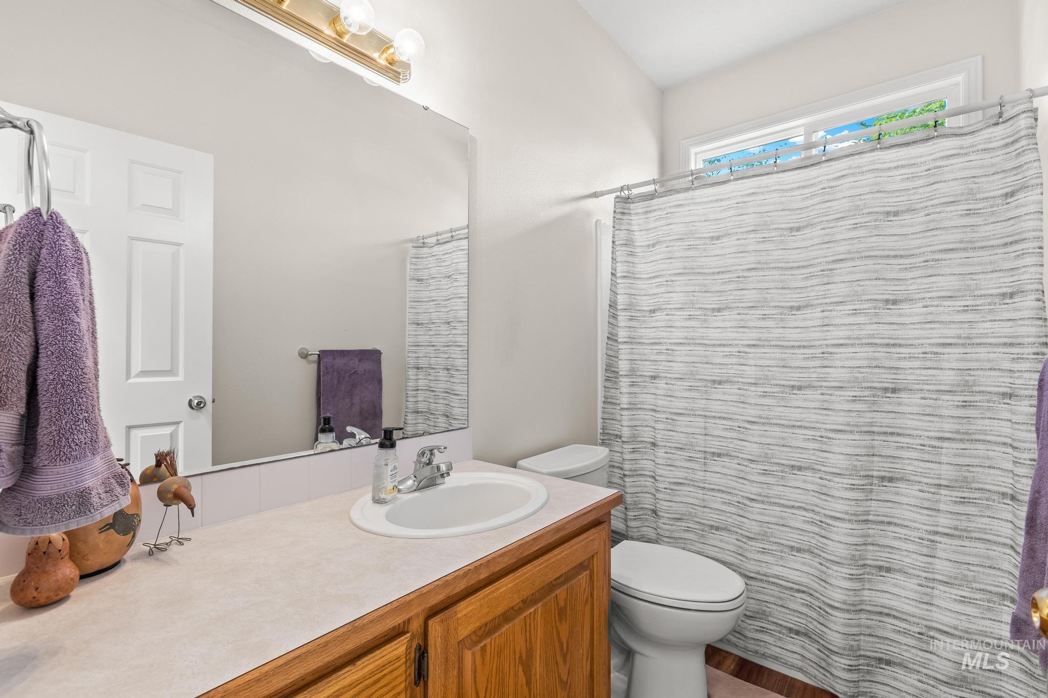 Full bathroom featuring vanity and a shower with curtain