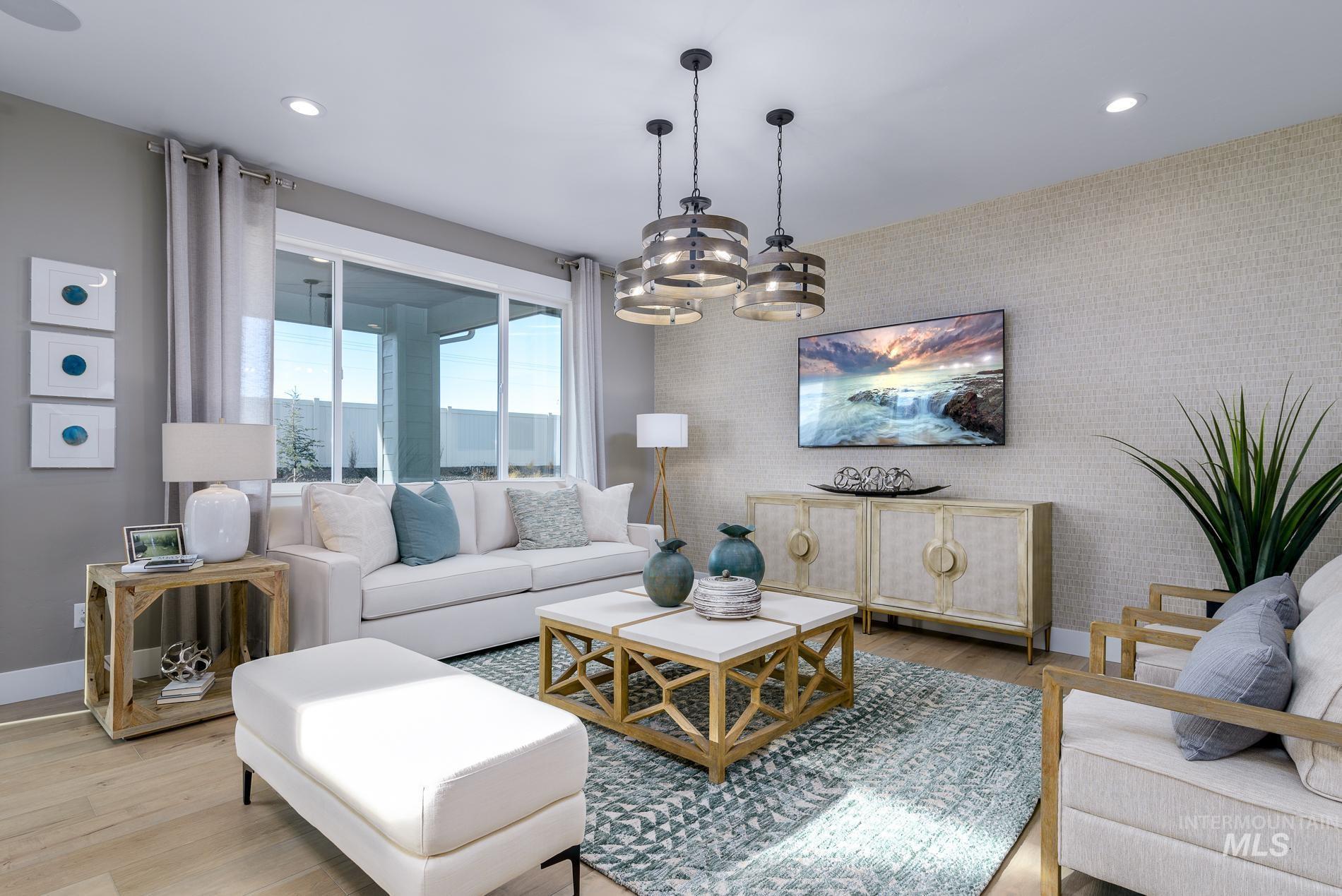 Living area featuring wood finished floors, a chandelier, recessed lighting, and wallpapered walls