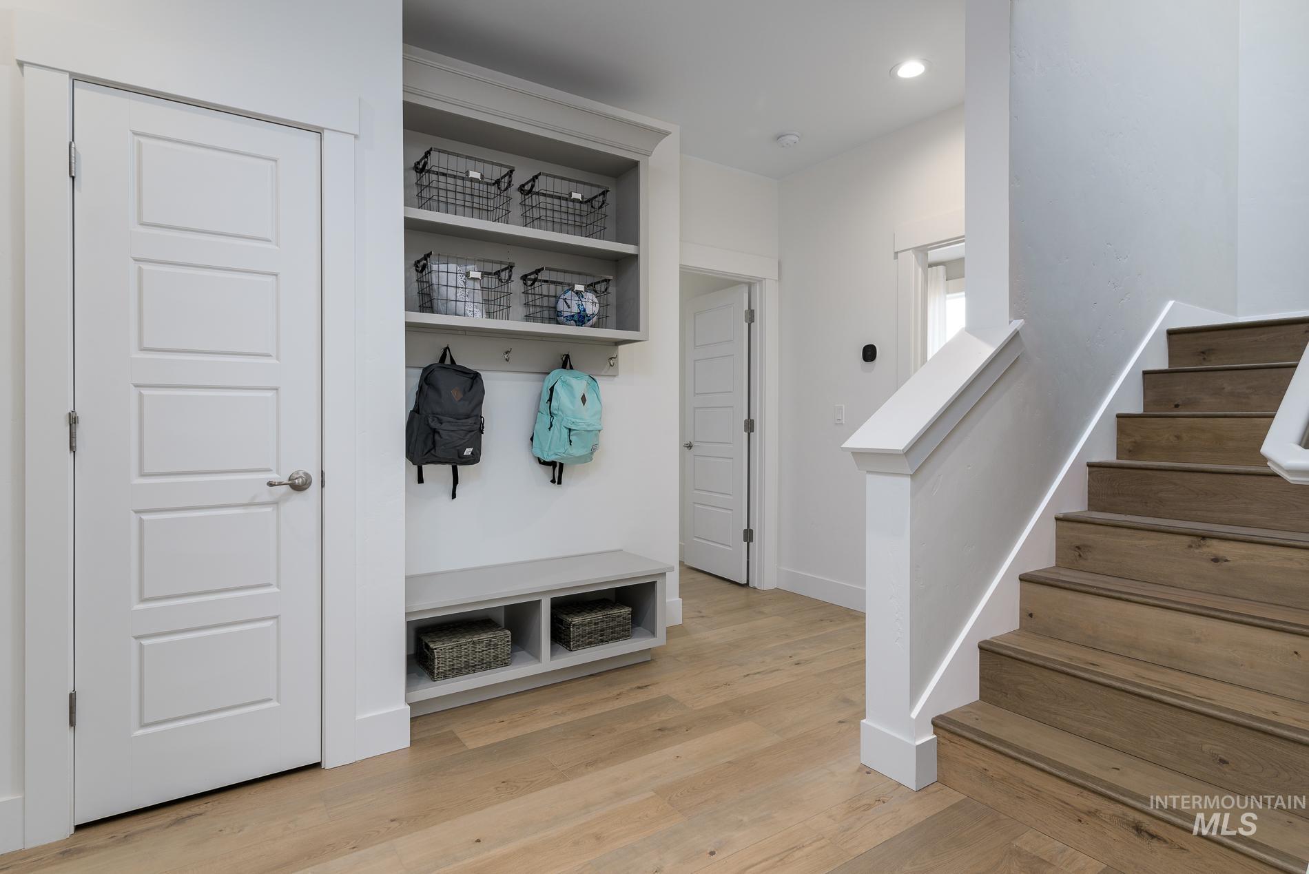 Mudroom featuring light wood finished floors and recessed lighting