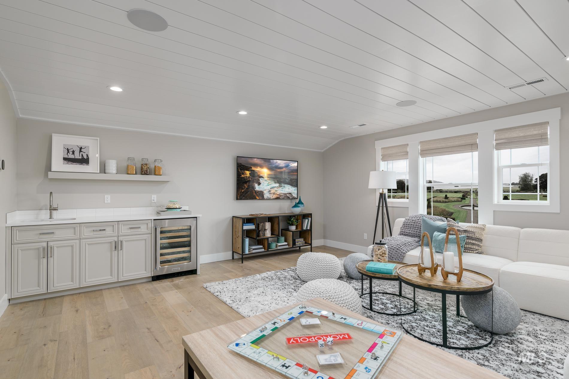 Living room with bar with sink, wine cooler, light wood-type flooring, recessed lighting, and wood ceiling