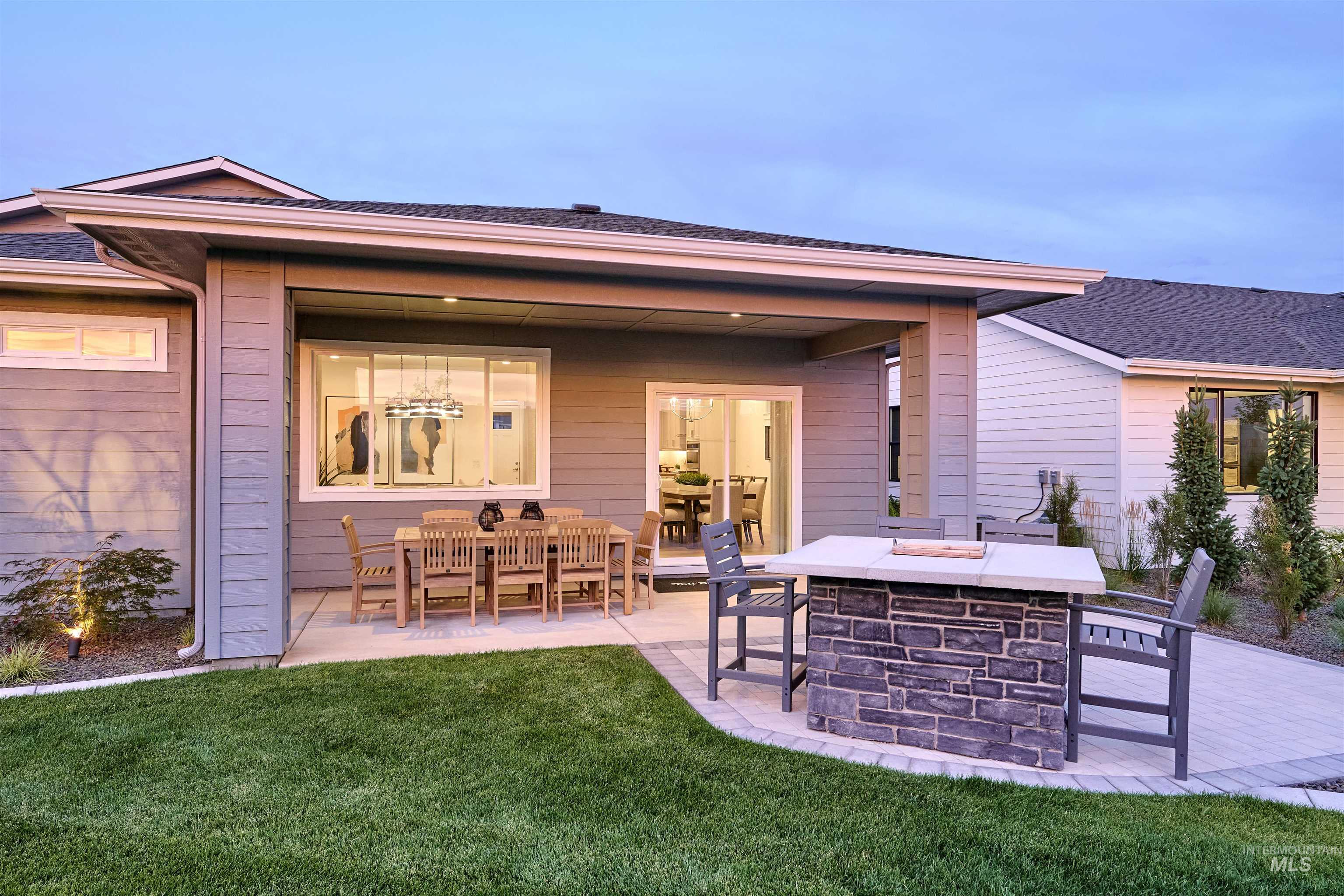 Rear view of house with a patio area, a yard, and a shingled roof