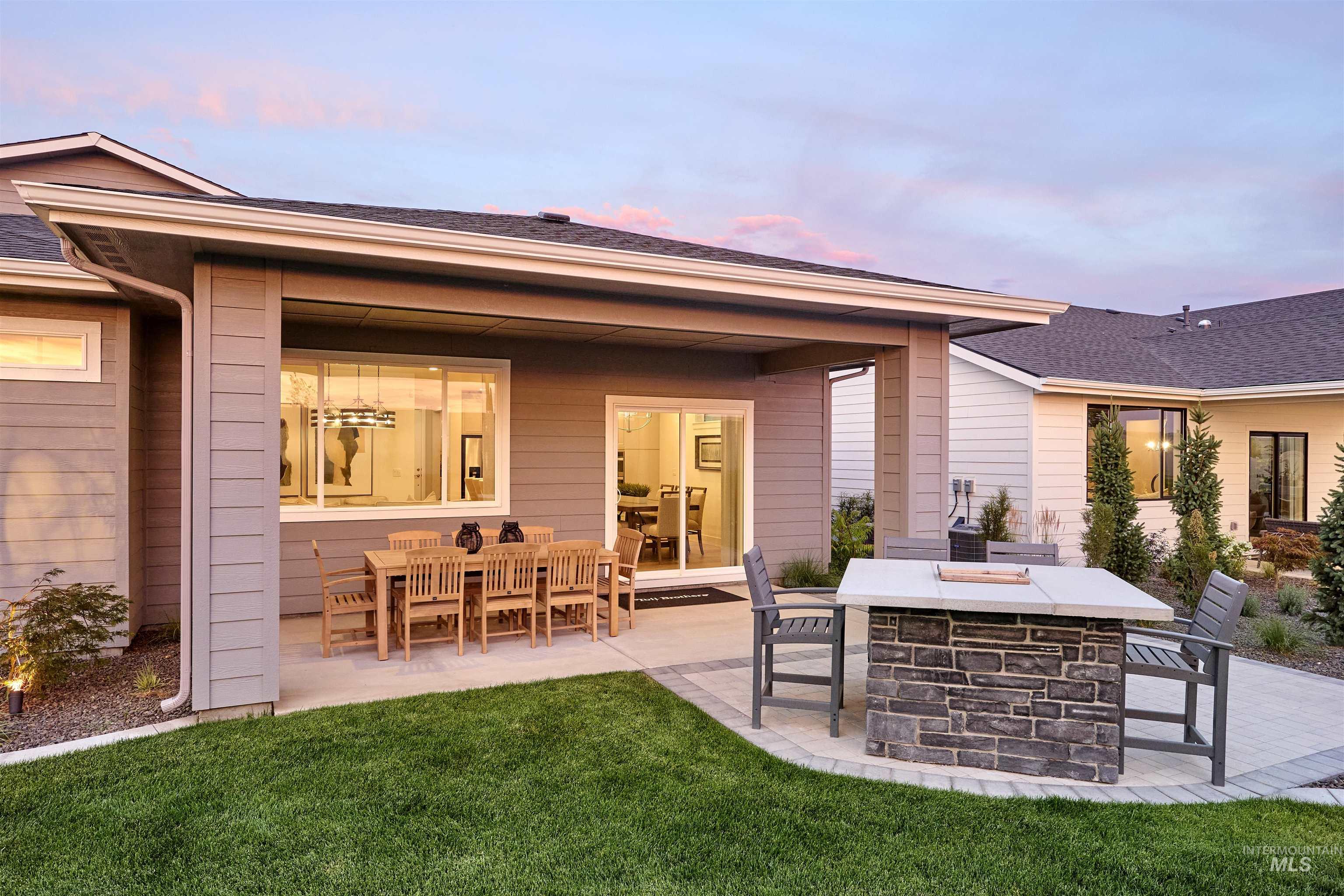 Back of house with a patio and a yard