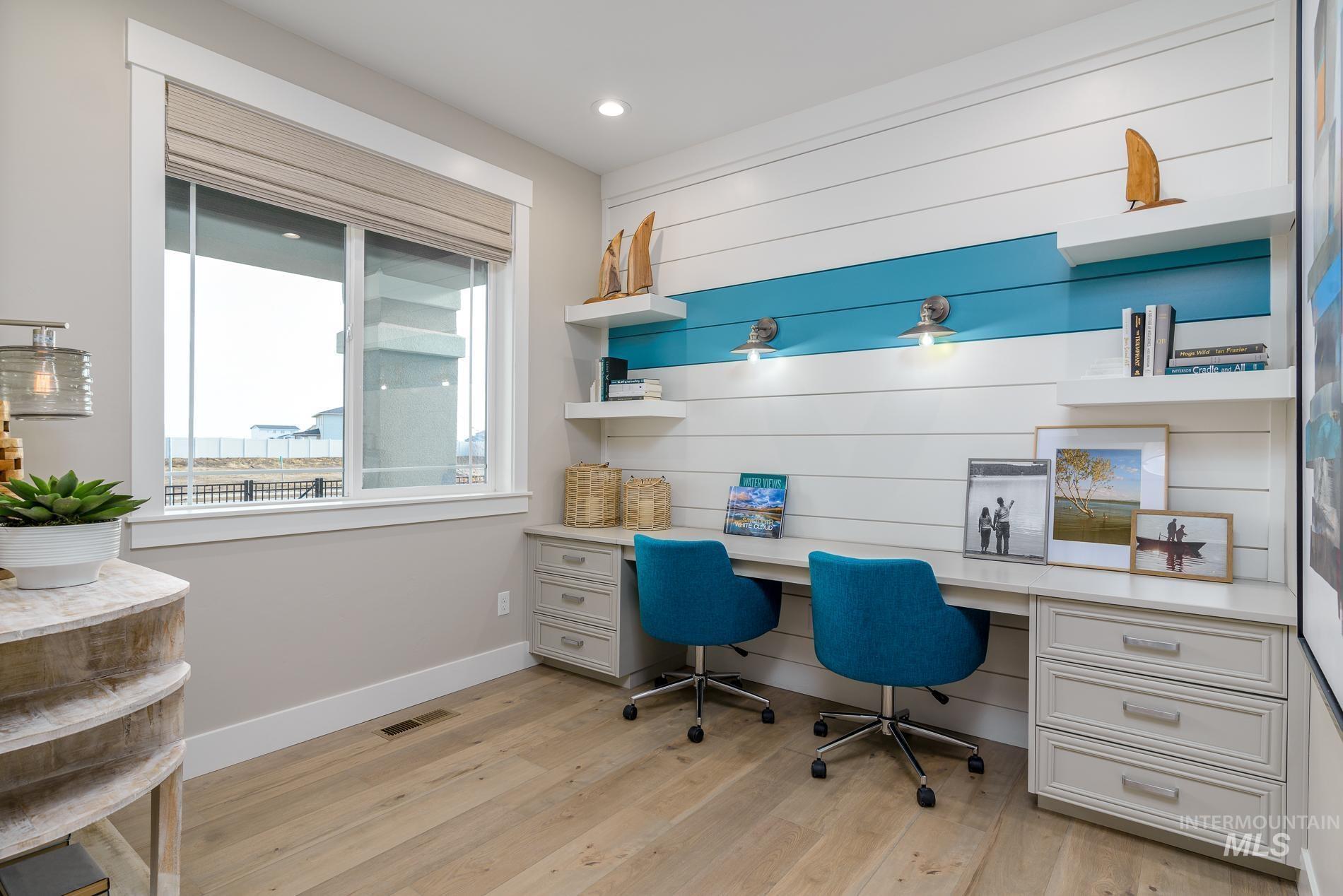 Office featuring built in study area, light wood finished floors, and recessed lighting