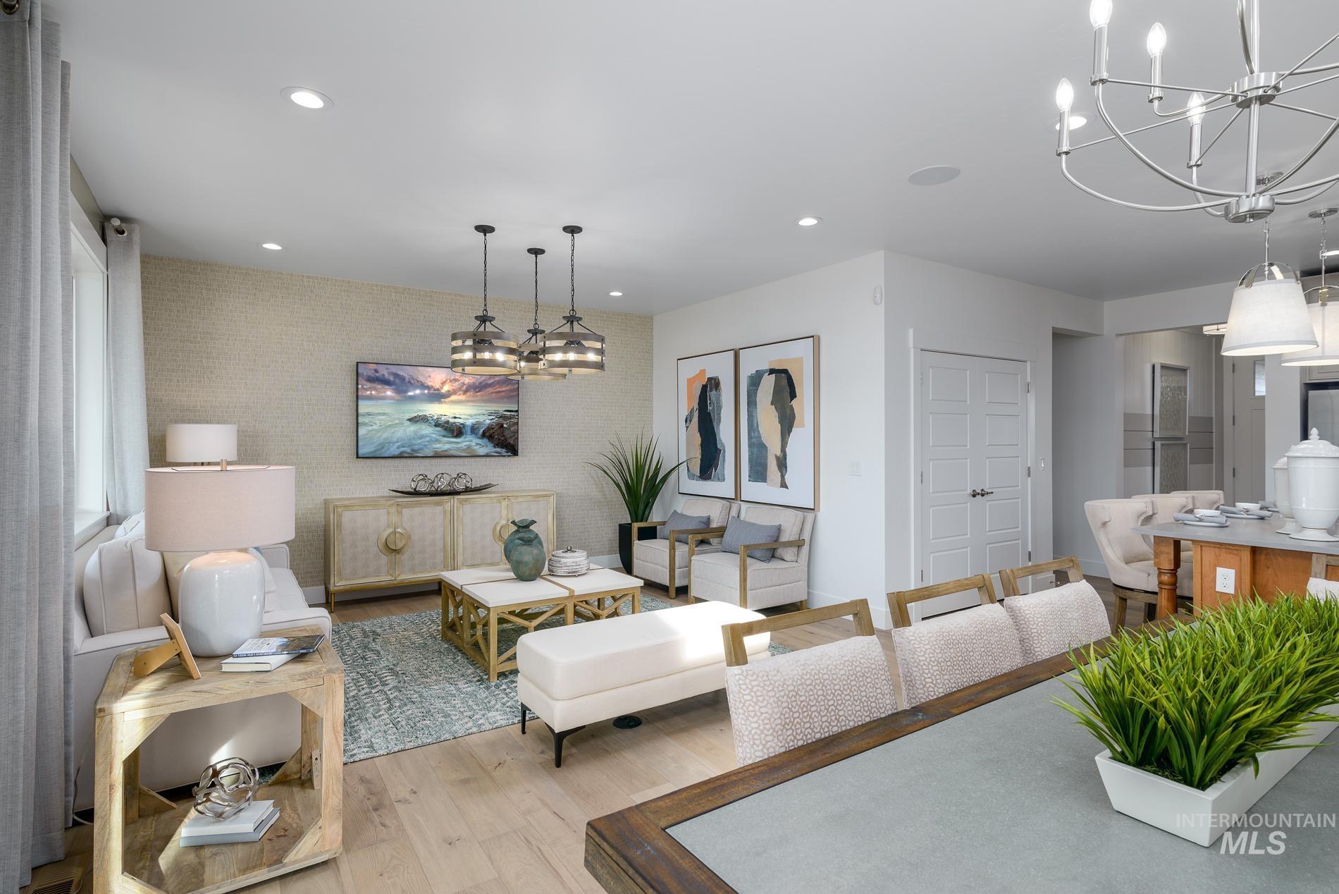 Living area with a chandelier, wood finished floors, and recessed lighting