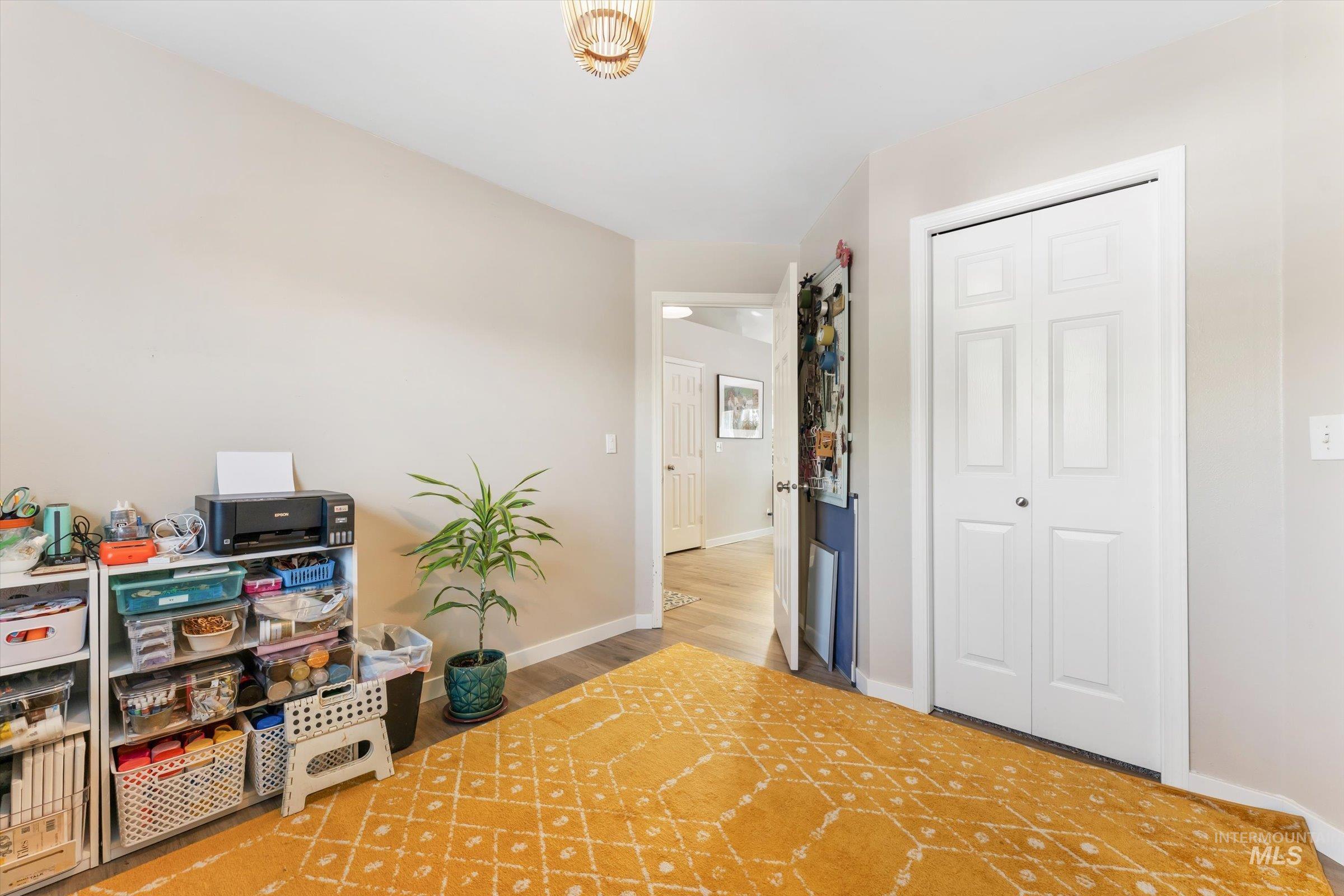 Interior space featuring baseboards and wood finished floors