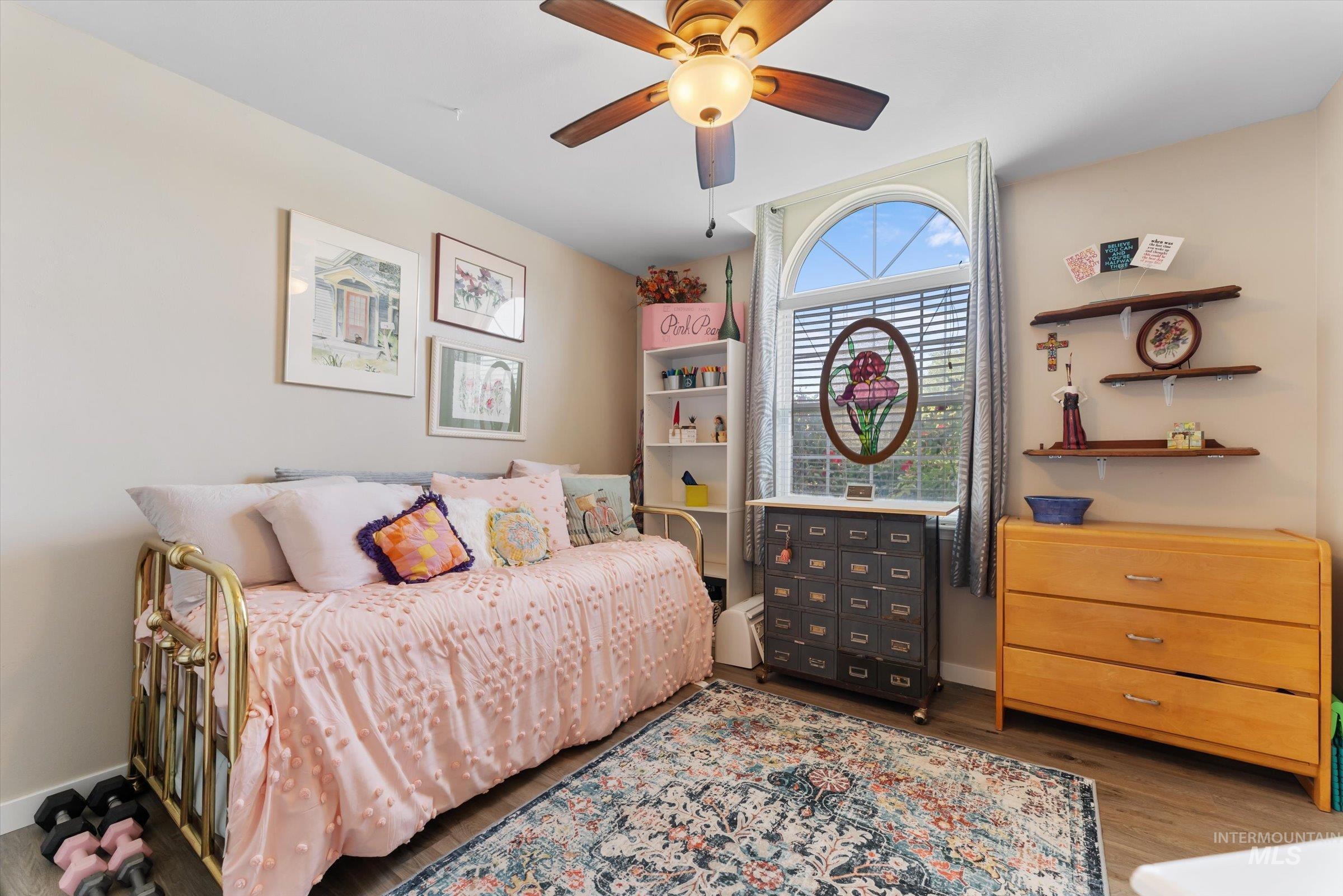 Bedroom with wood finished floors and ceiling fan