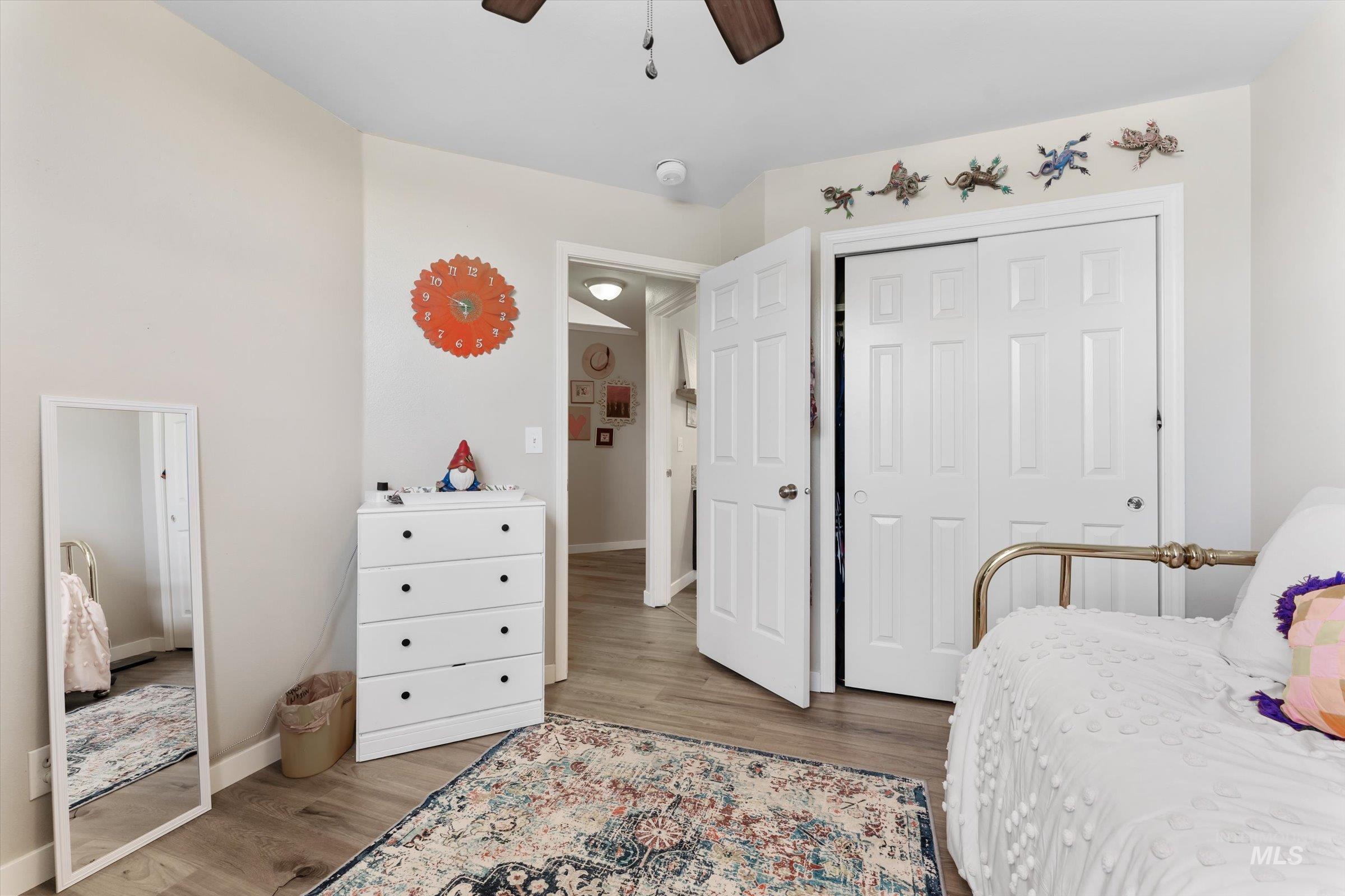 Bedroom featuring a closet, wood finished floors, and a ceiling fan