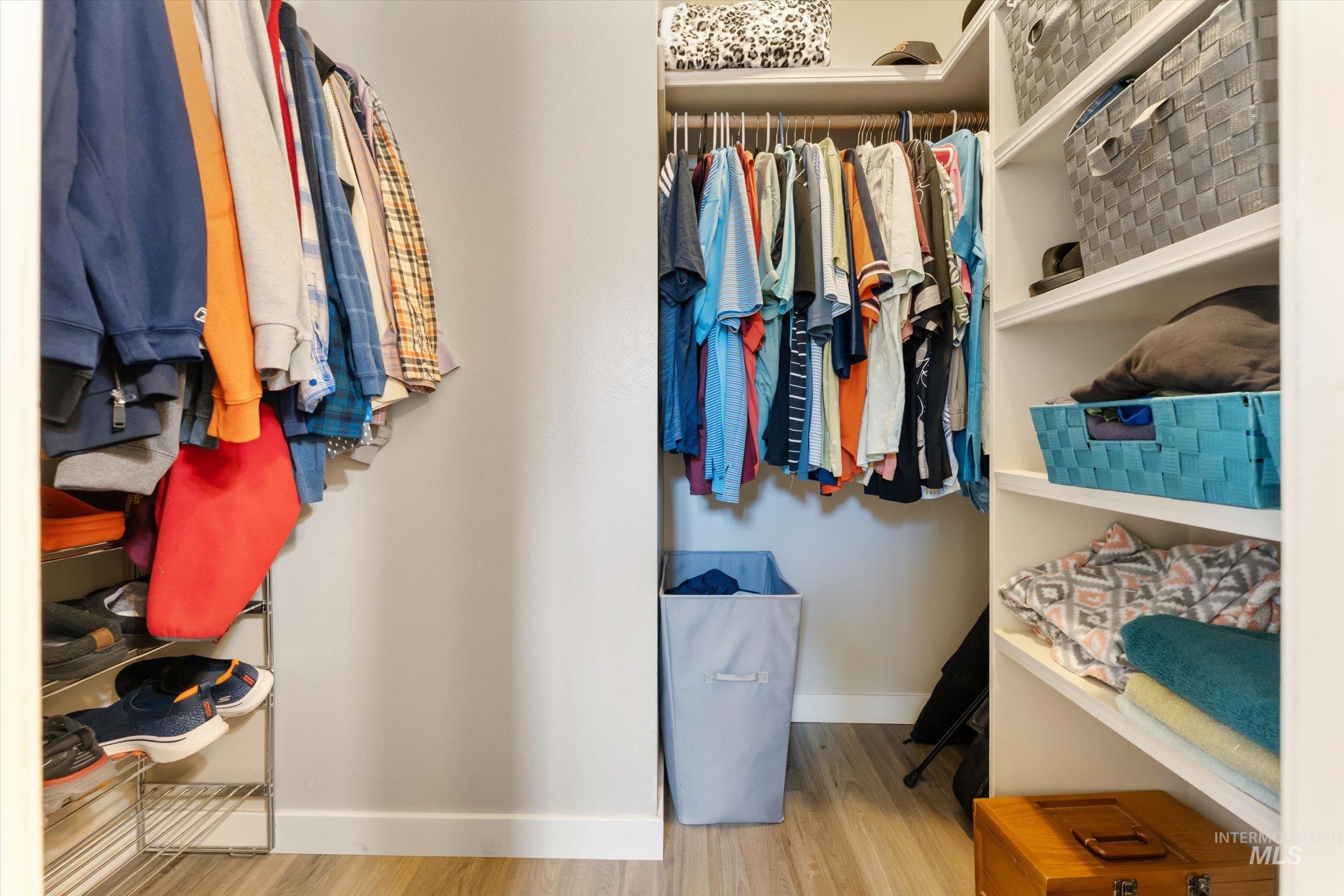 Spacious closet with light wood-style flooring