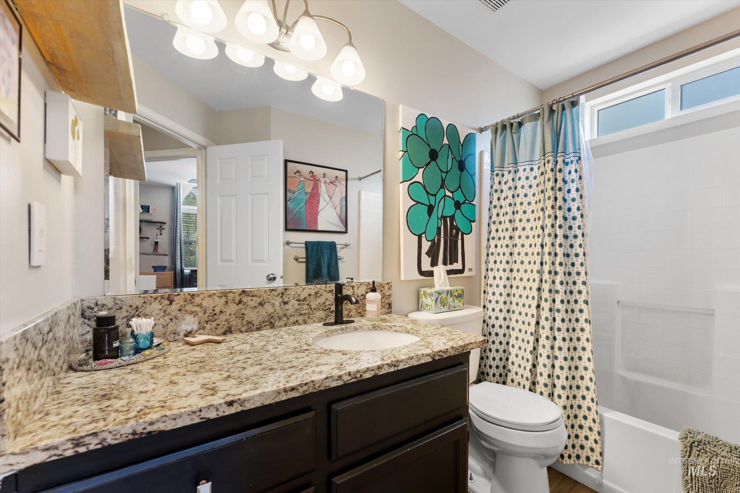 Full bathroom with vanity and shower / bath combination with curtain