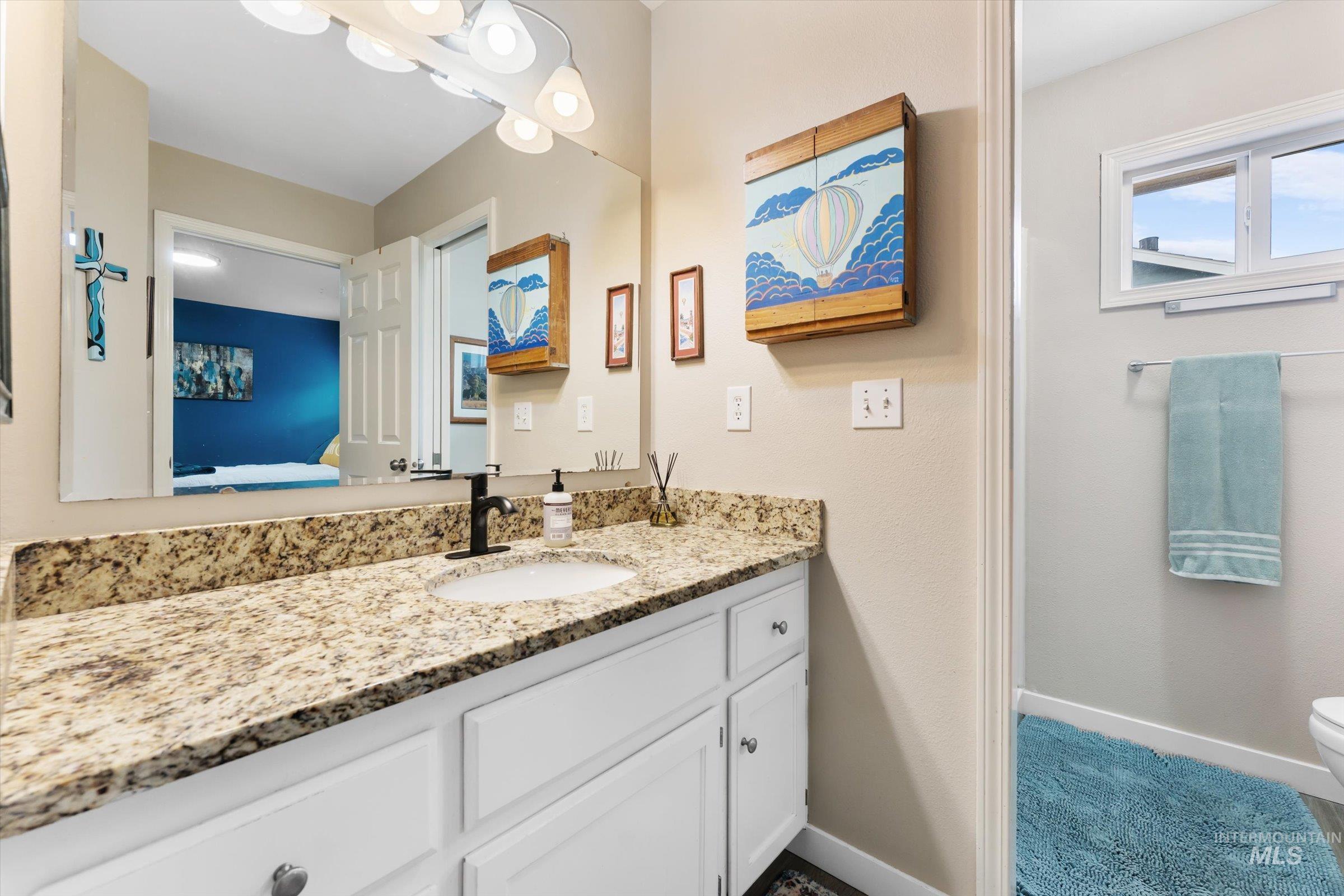 Ensuite bathroom with vanity and baseboards