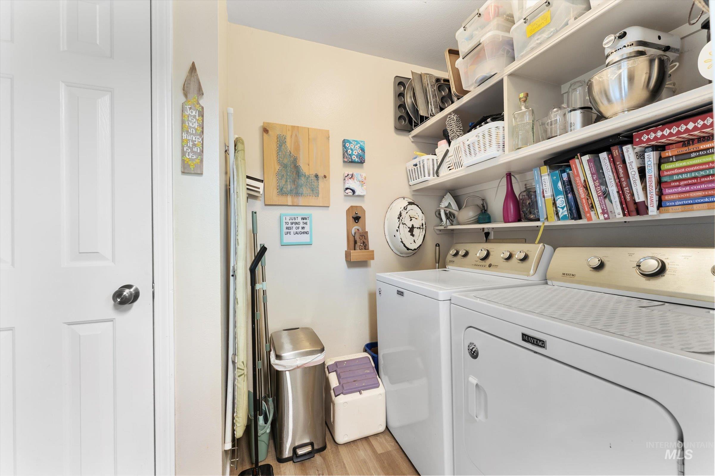 Laundry area featuring independent washer and dryer and light wood-style floors