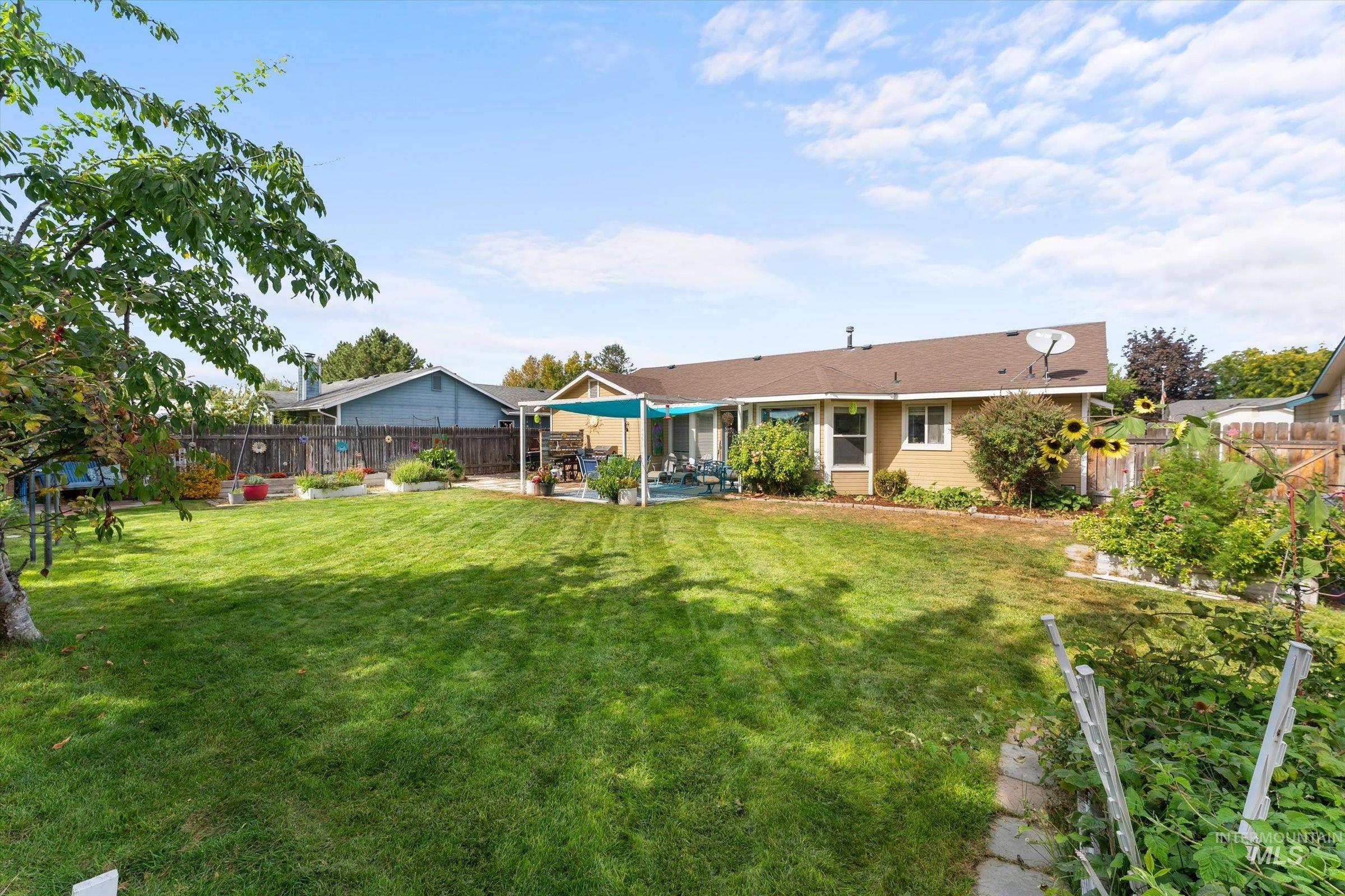 Rear view of property with a fenced backyard and a patio