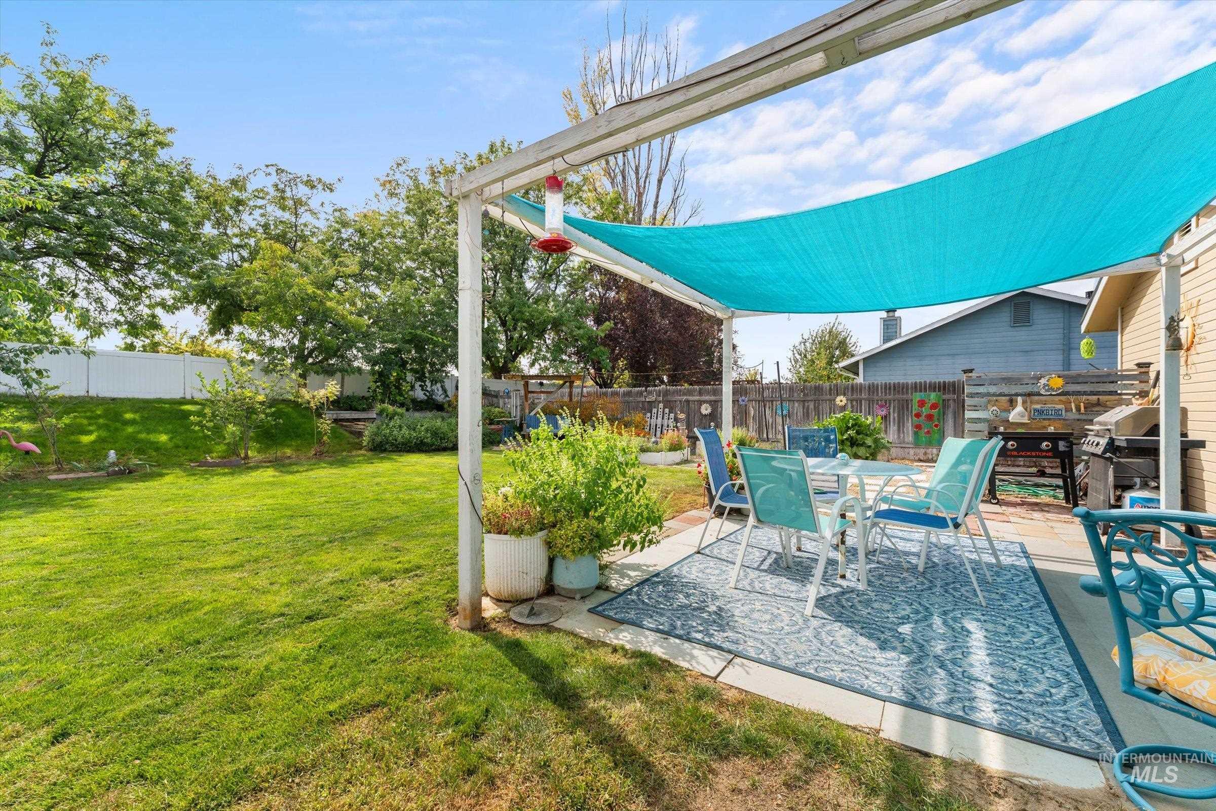 Fenced backyard with a patio and outdoor dining space