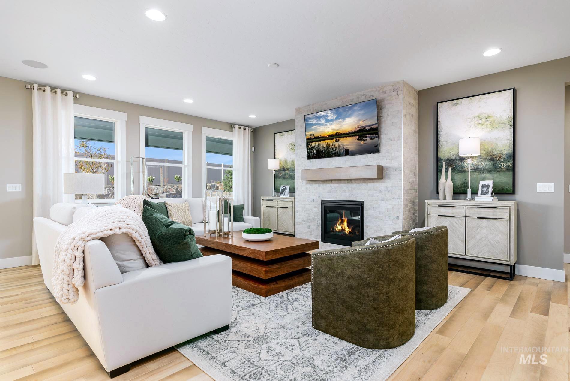 Living room featuring light wood-style floors, recessed lighting, and a fireplace
